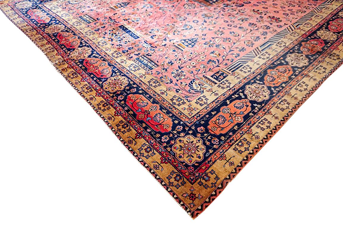 Antique Persian Manchester Kashan, circa 1900. The wonderful rose field with bold floral motifs surrounded by yellow and navy border gives this rug a look and feel of quality and importance. The term Manchester signifies that the wool used is very