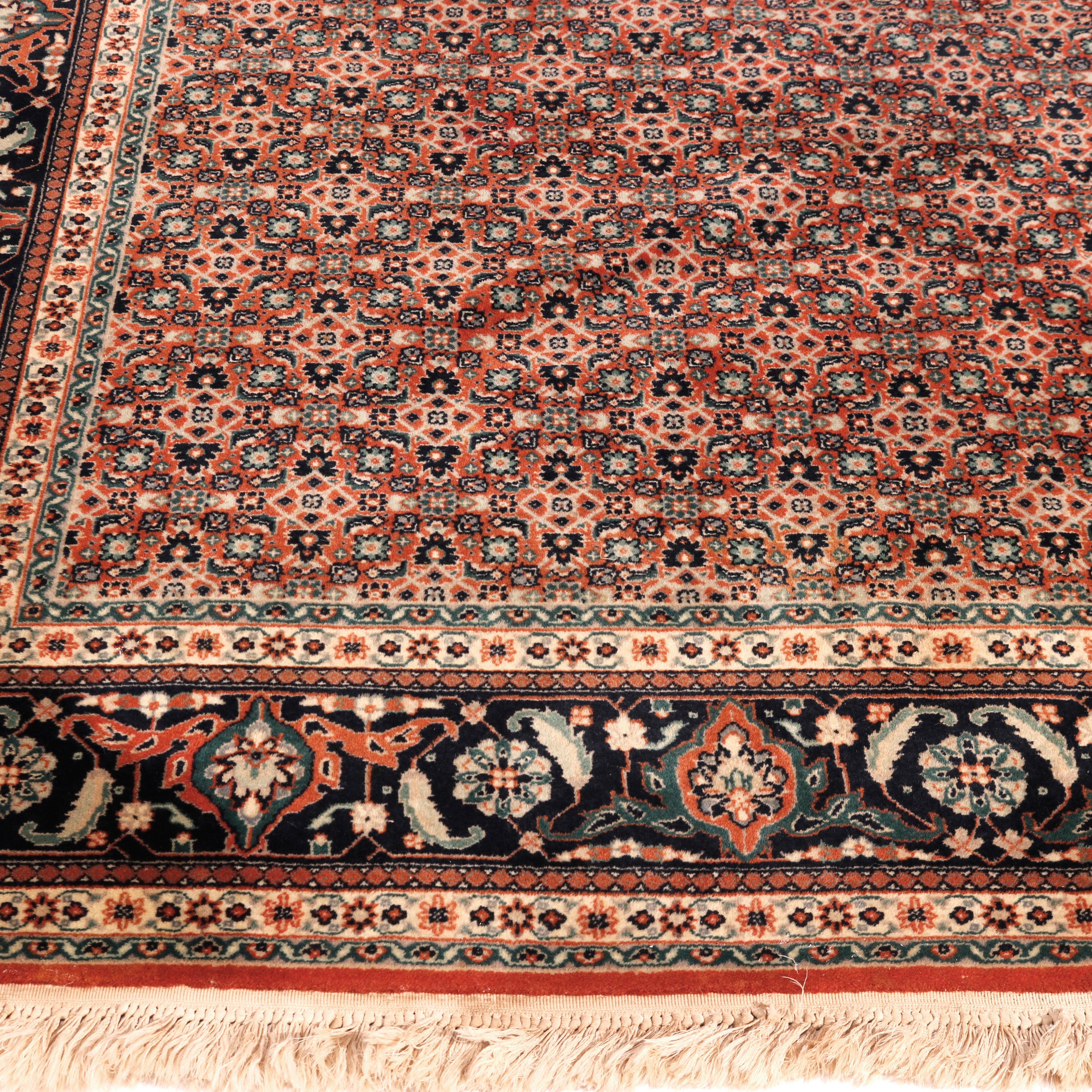A Kashan room size oriental rug offers wool construction with allover floral design, circa 1950

Measures - 113