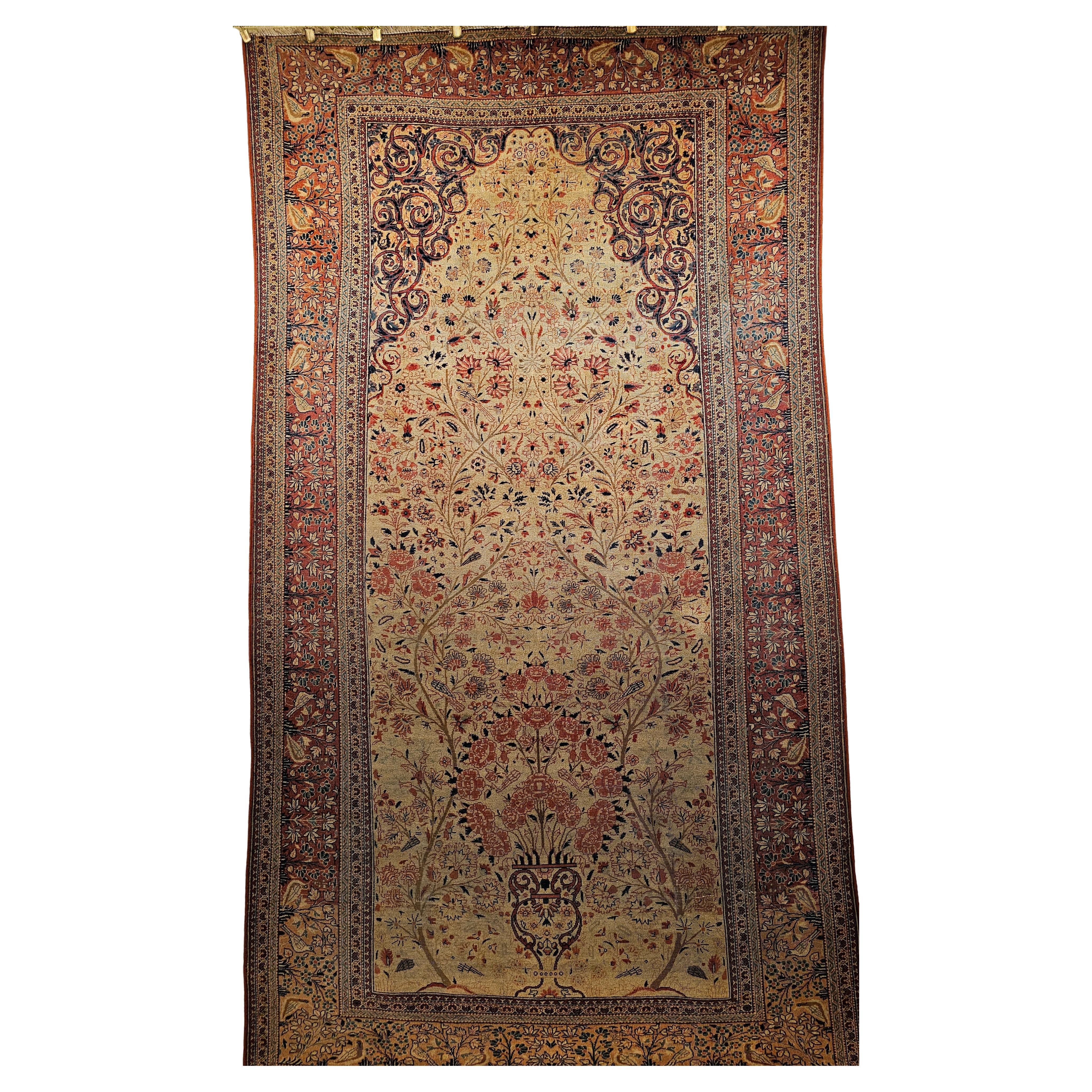 The 19th century Persian Kashan library rug with a Vase “Tree of Life” design with birds on branches elevating towards the heavens. The field is a very rare and desirable ivory color.   The gorgeous border is in a rust red color with the birds