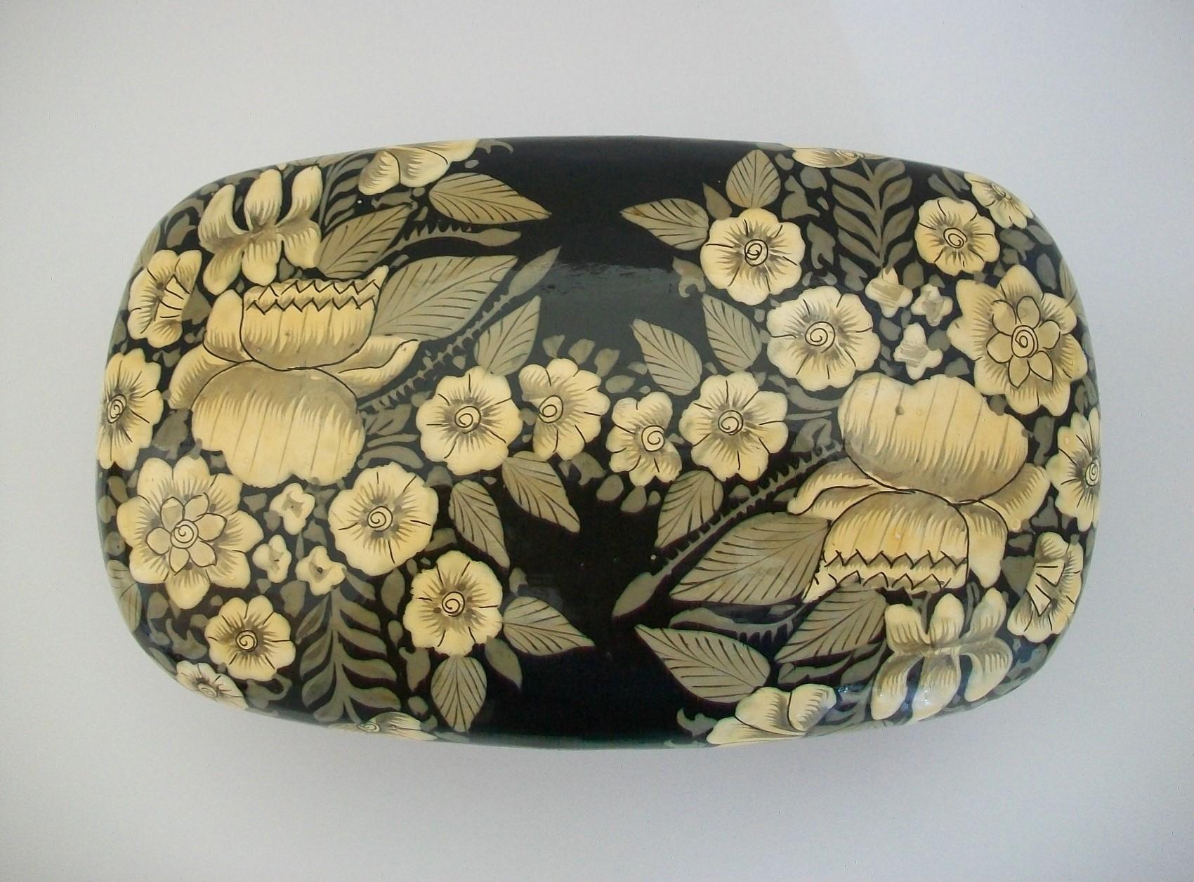 Vintage South Asian / Kashmir hand painted papier mâché box with removeable lid - featuring a profuse floral pattern over the top and sides set against a black lacquer background - high gloss finish - remnants of original paper label to the base -