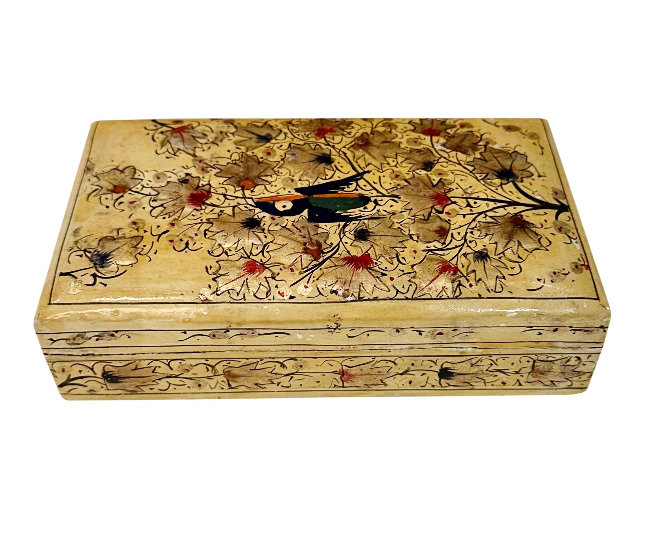 Turn of the century wooden Kashmir box. Hand painted with a striking black bird in the center surrounded by red and black accented leaves.