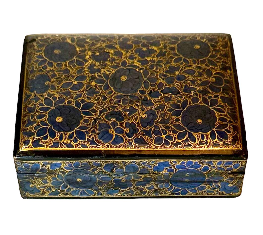 A wonderful hand-painted papier-mâché box beautifully decorated in a blue and gold. Kashmir, India, circa turn of the century.