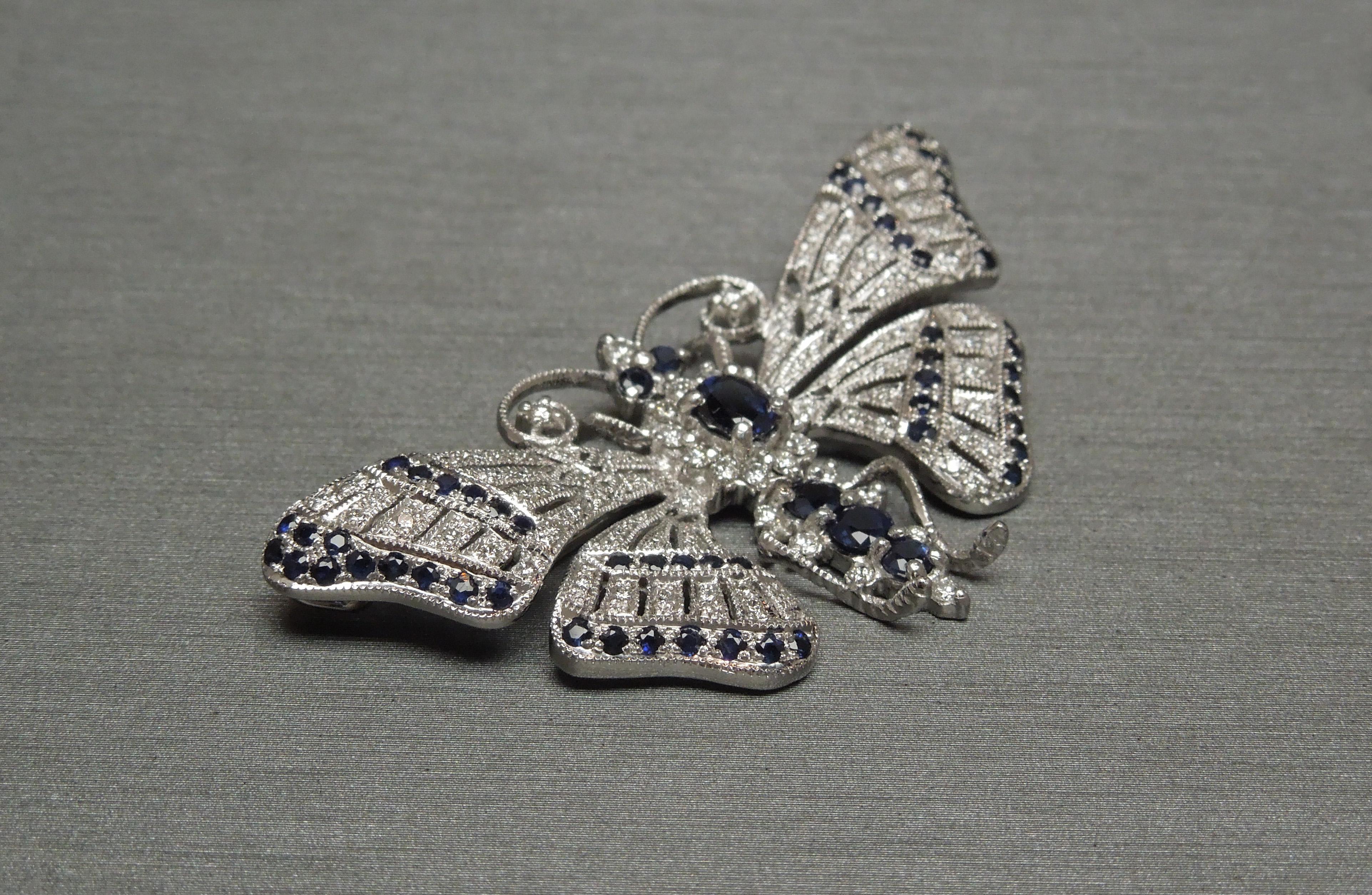 Doubling as a pin OR a slide pendant, this 18KT White Gold Butterfly consists of focal Kashmir Blue Sapphires & accent Diamonds. The body containing 1 Central 0.50 carat Oval cut Natural Kashmir Blue Sapphire secured in four prongs with 5 Round cuts