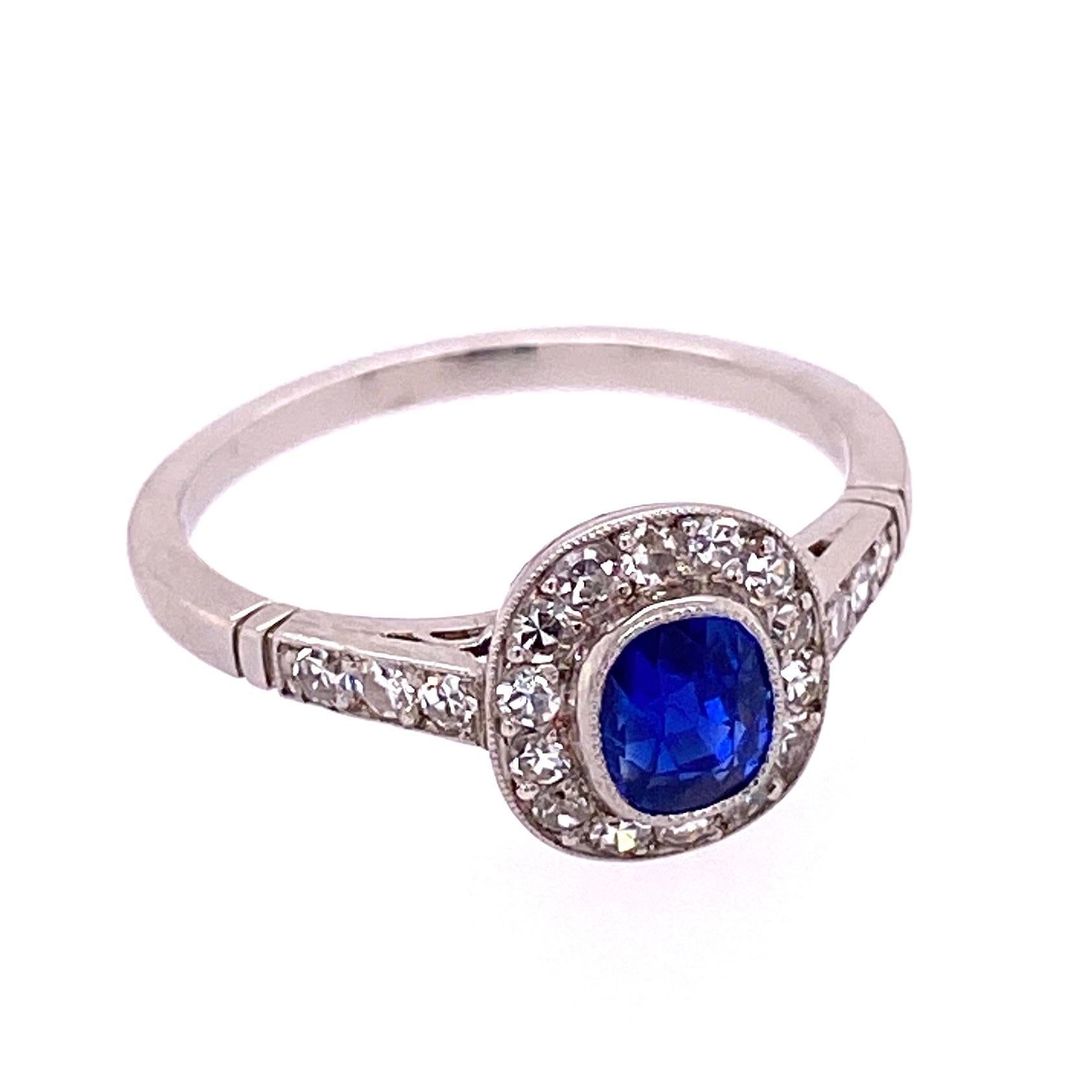 Beautiful, Elegant and finely detailed Edwardian Platinum Engagement Ring, center securely nestled with a Kashmir No Heat Blue Sapphire, GIA #2205902539, weighing approx. 0.99 Carats; surrounded by Diamonds and small Diamonds enhancing the shank;