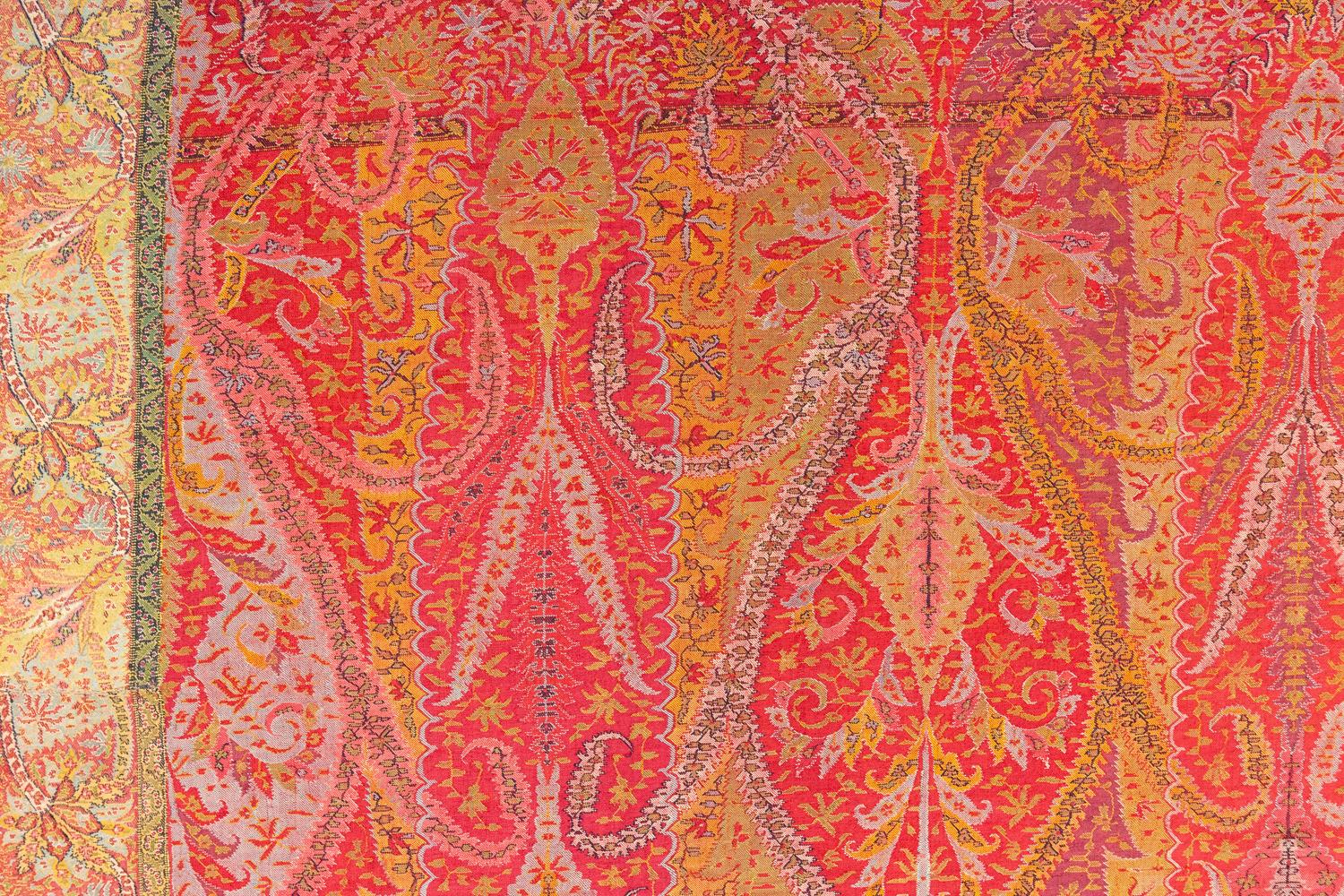 This is an antique Indian cashmere shawl woven during the beginning of the 19th century circa 1800 -1820’s and measures 315 x 144CM in size. The design of this piece is created with two center columns decorated with Paisley and arabesque motifs