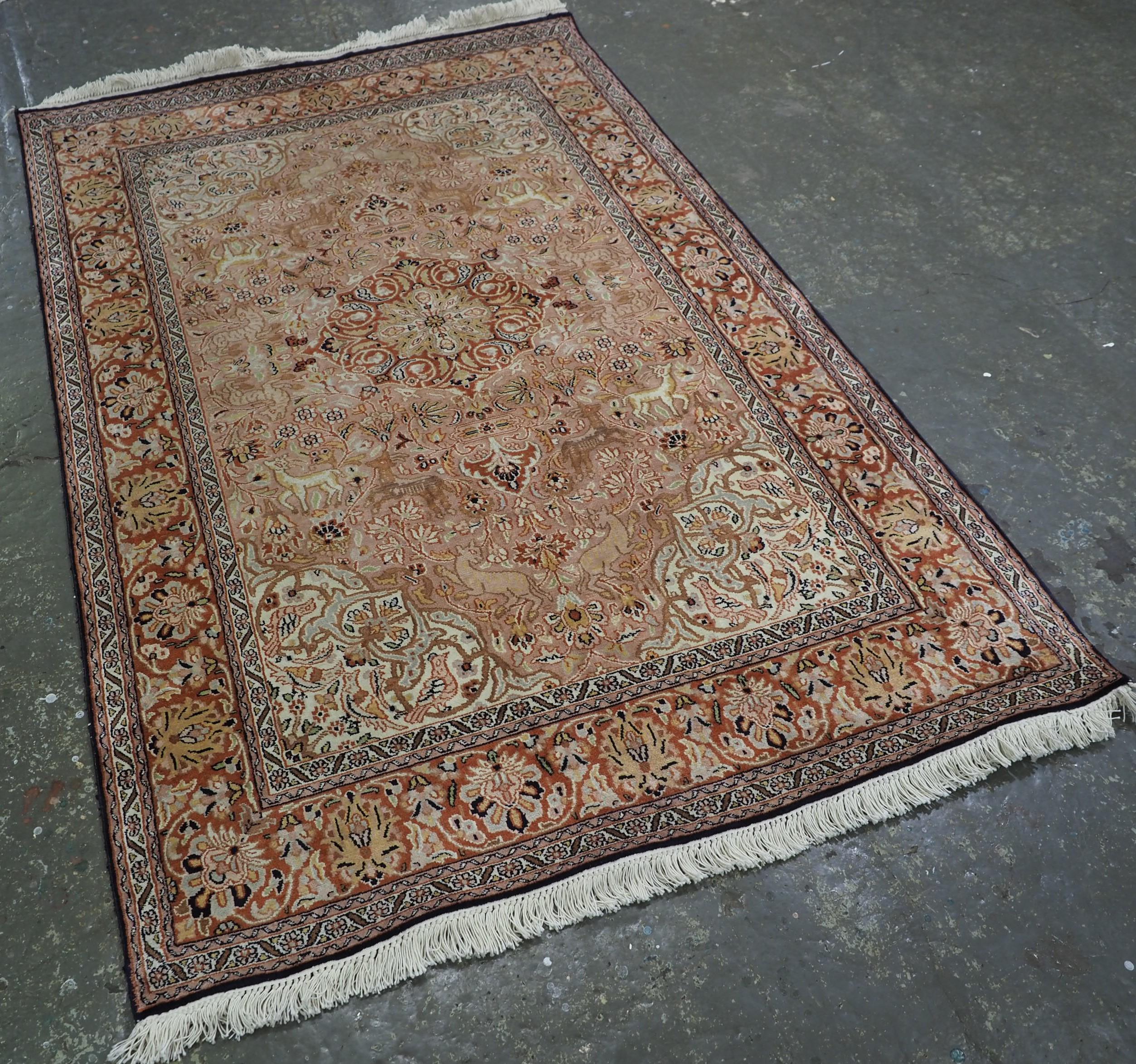 
Size: 6ft 0in x 4ft 0in (184 x 123cm).

A good example of a Kashmir silk rug with a small medallion design, surrounded by a garden of animals and flowers.

About 30 years old.

The rug has a very soft colour palette with warm tones, making it ideal