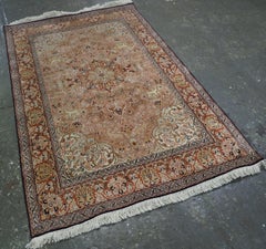 Kashmir silk rug with a small medallion design in garden of animals & flowers.