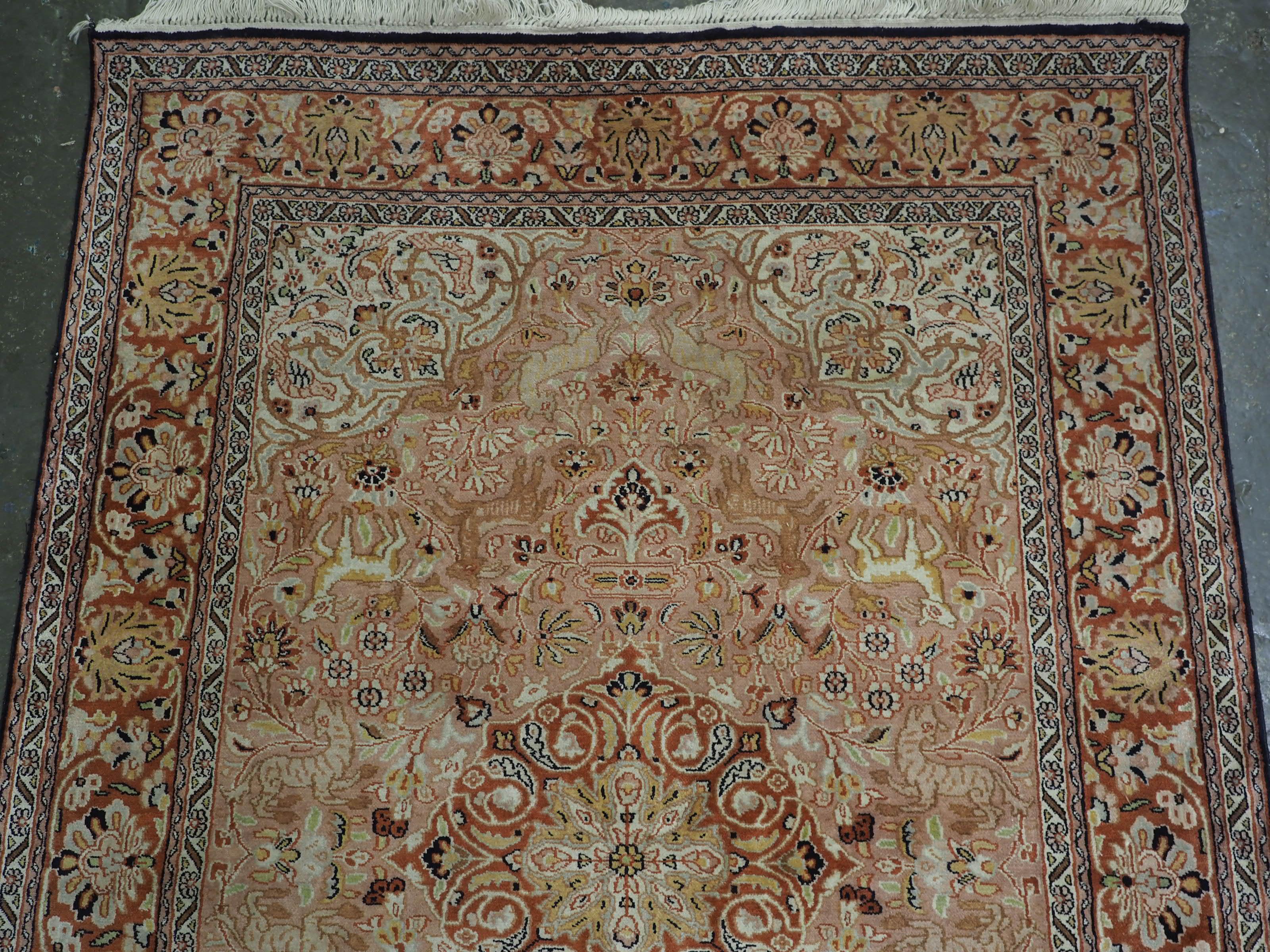 Indian Kashmir silk rug with a small medallion design in garden of animals & flowers. For Sale
