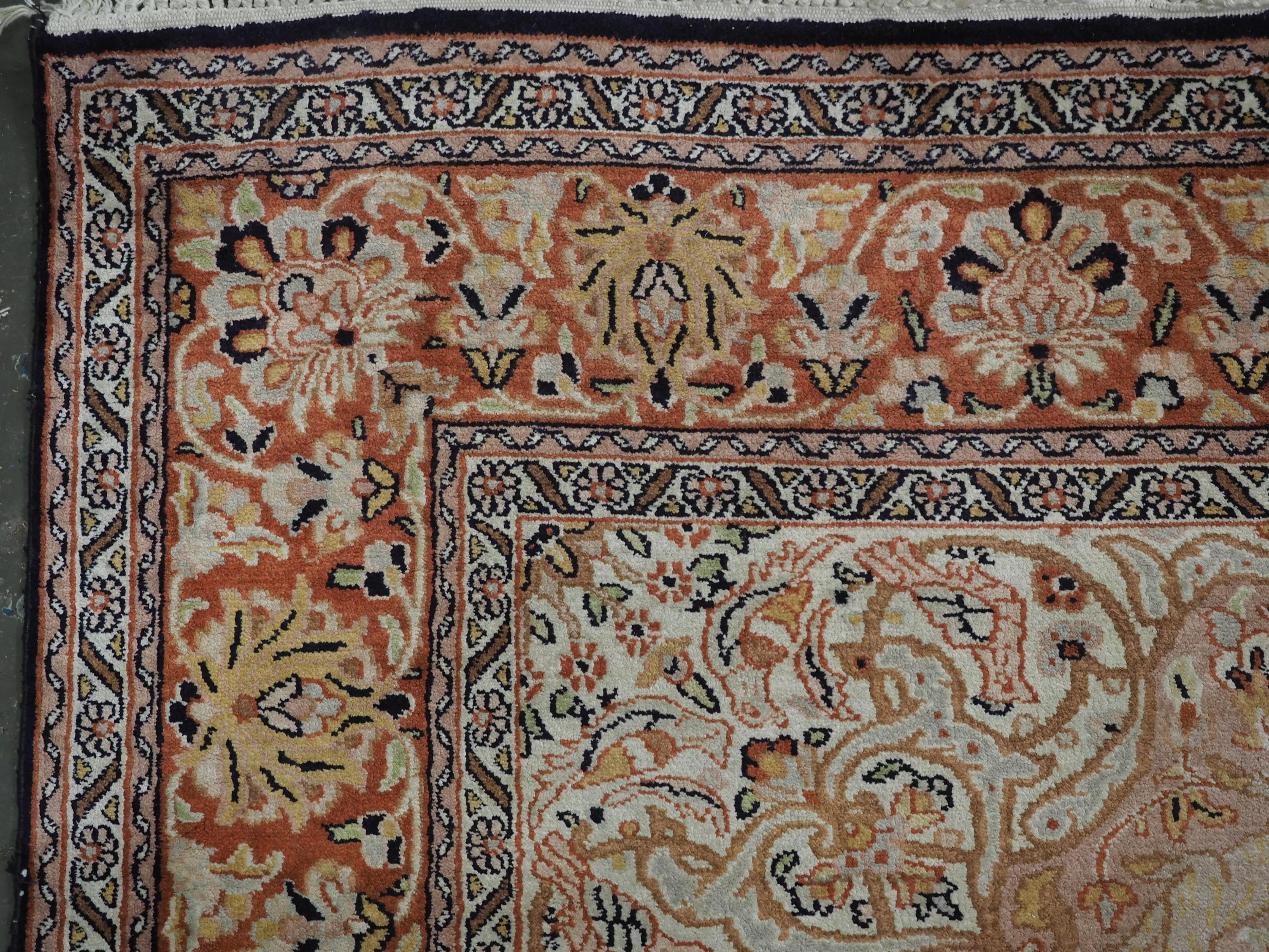 Silk Kashmir silk rug with a small medallion design in garden of animals & flowers. For Sale