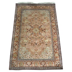Antique Kashmir silk rug with a small medallion design in garden of animals & flowers.
