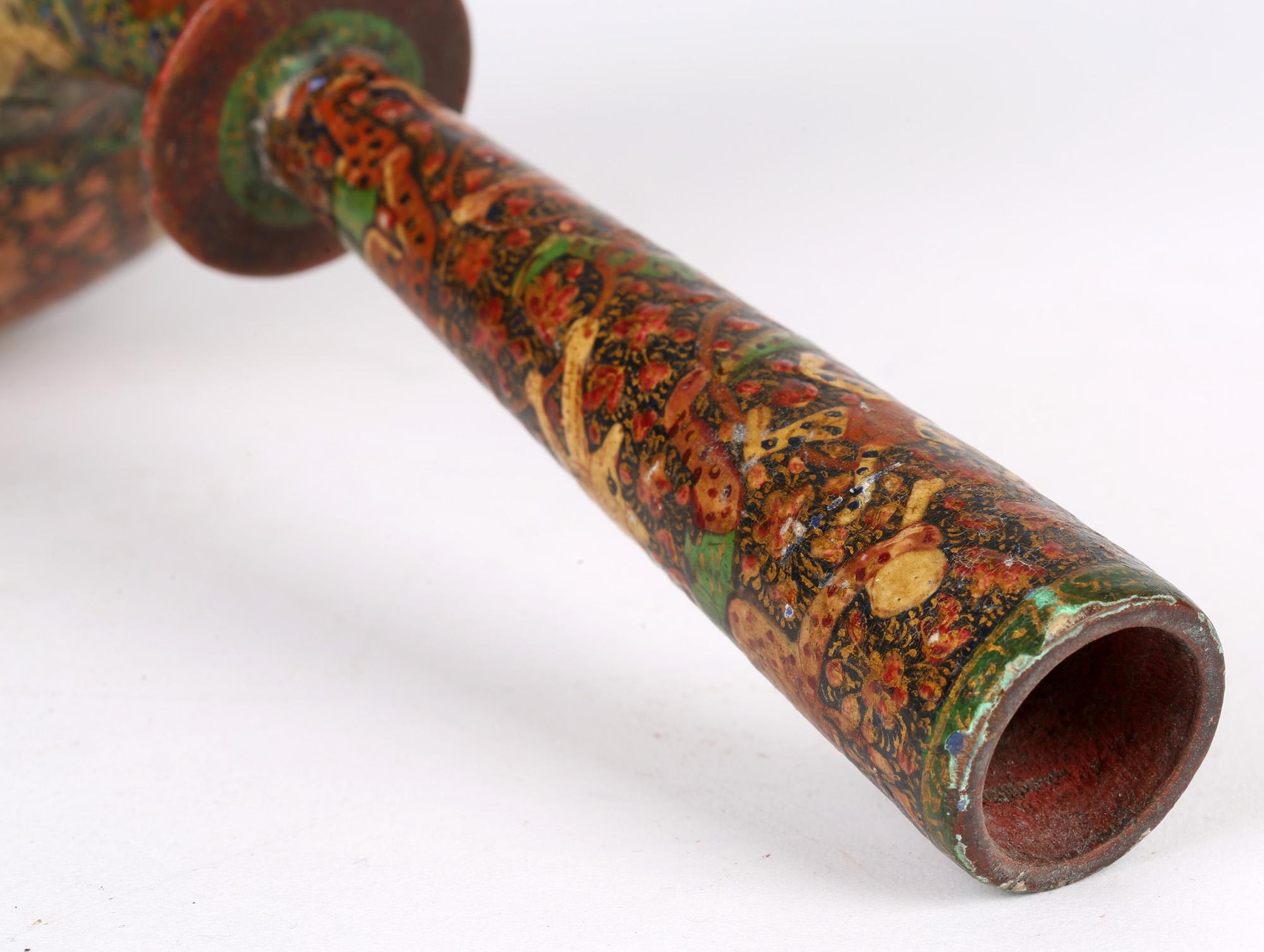 A rare and unusual Indian Kashmiri lacquer vase with mythical characters dating from the 19th century, possibly early. The wooden vase stands on a narrow rounded foot with a squat wide rounded body and a tall slender neck with a disc design. The