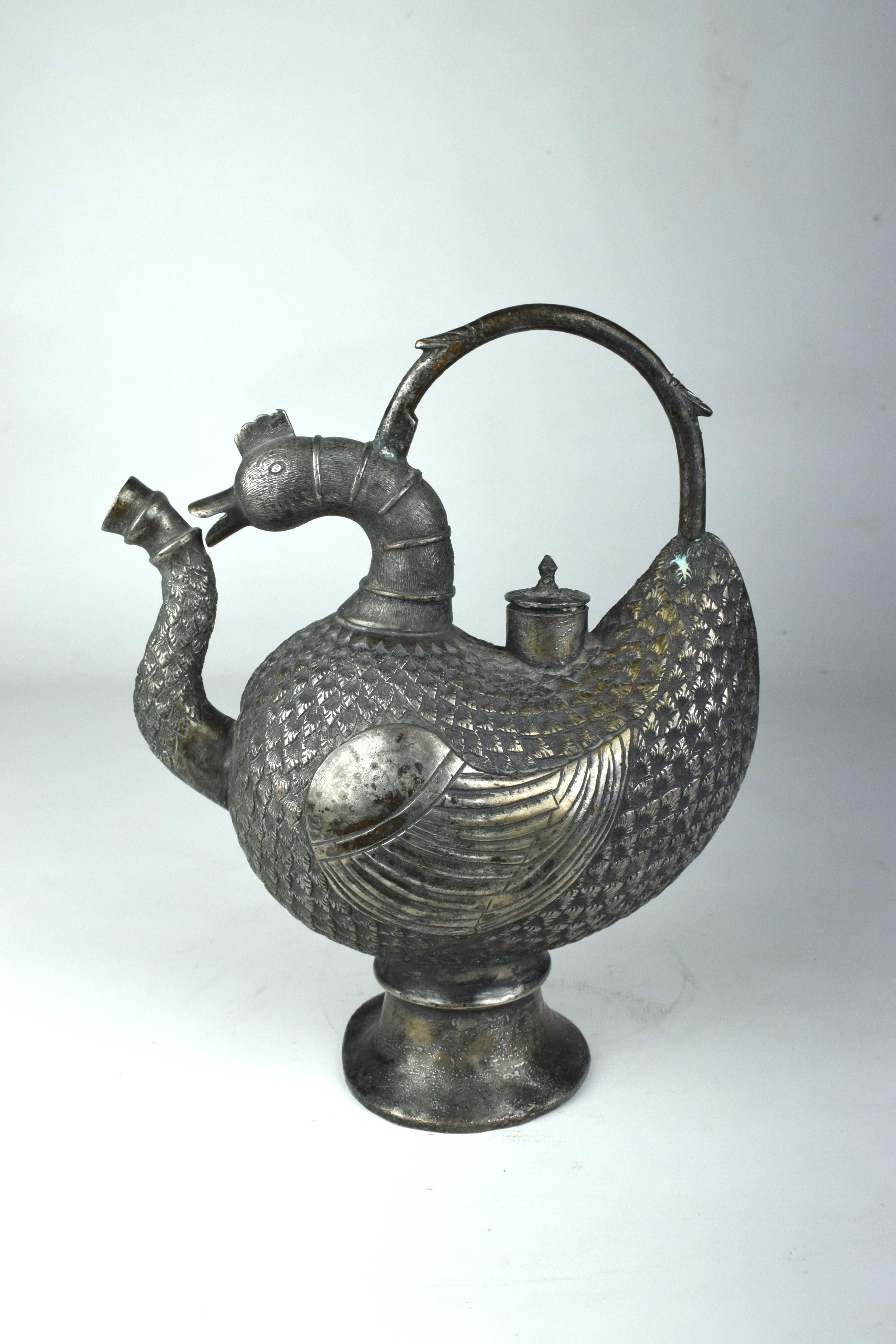 This exquisite piece of art seamlessly combines the intricate aesthetics of Mughal design with the skilled craftsmanship of Kashmiri artisans, resulting in a stunning and unique creation.

The copper ewer takes the form of a bird, with its body