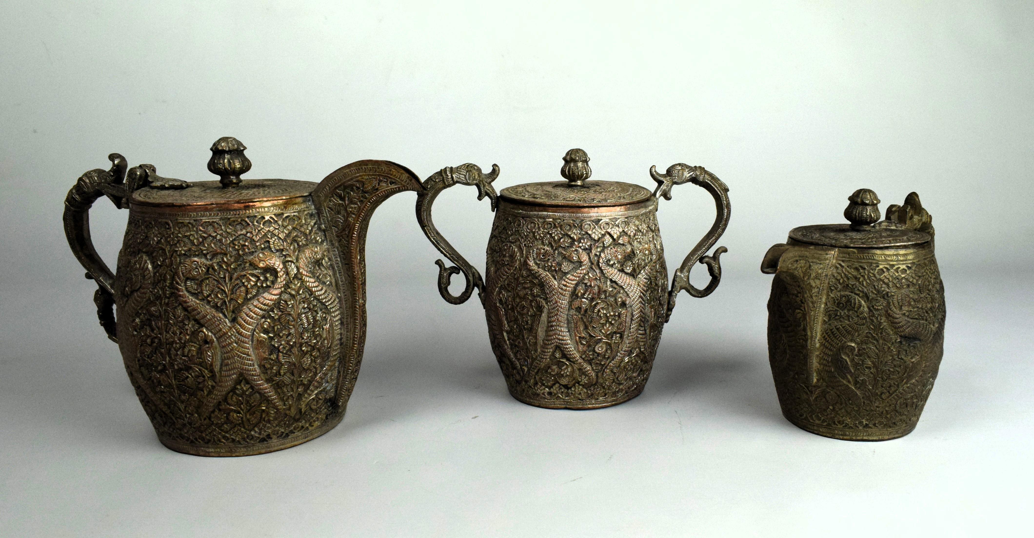 This 19th-century Kashmiri Mughal copper tea set, consisting of a saucer, sugar pot, and milk pot, is a magnificent representation of the region's rich artistic heritage and the influence of Mughal aesthetics. 

The saucer, sugar pot, and milk pot