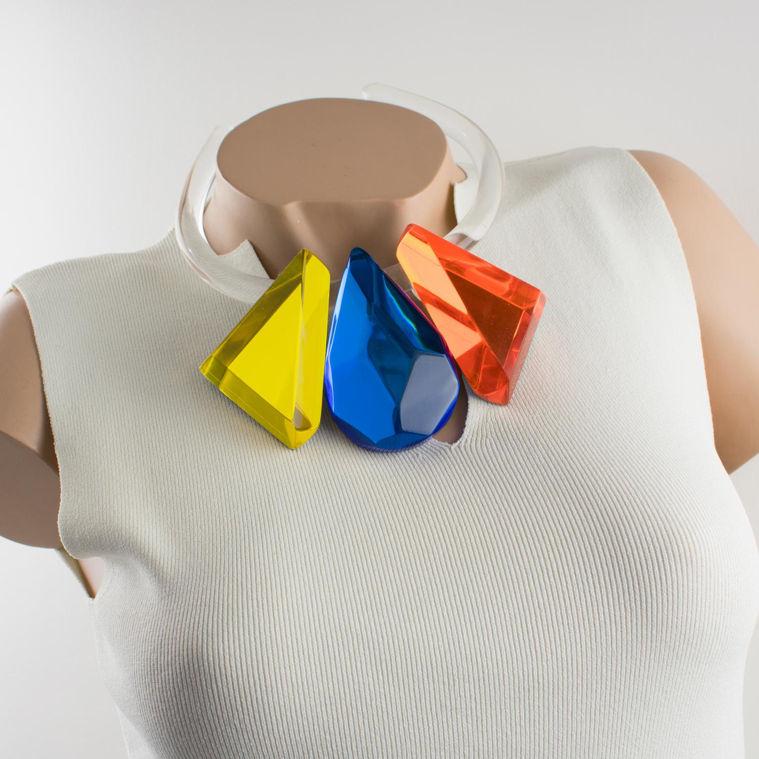 This four-in-one necklace is a spectacular Lucite choker designed by Harriet Bauknight for Kaso. The piece features a transparent Lucite or acrylic resin round molded choker contoured to the neck, ornate with three removable pendants. The rigid