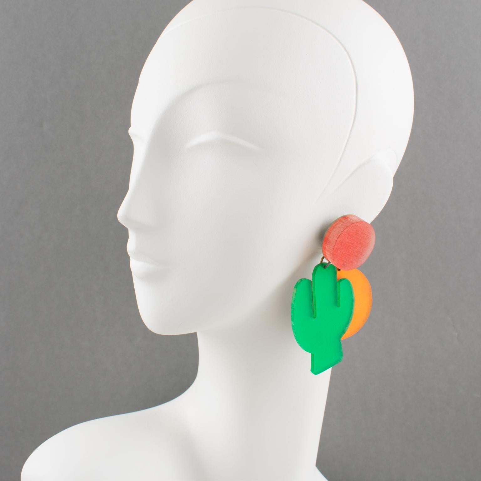 Harriet Bauknight designed those stunning massive Lucite dangling clip-on earrings for Kaso in the 1980s. 
Do you feel the hot wind and the burning sun? It's the call of the arid desert, its zenith sun, and its giant cactus.
These pieces boast a sun