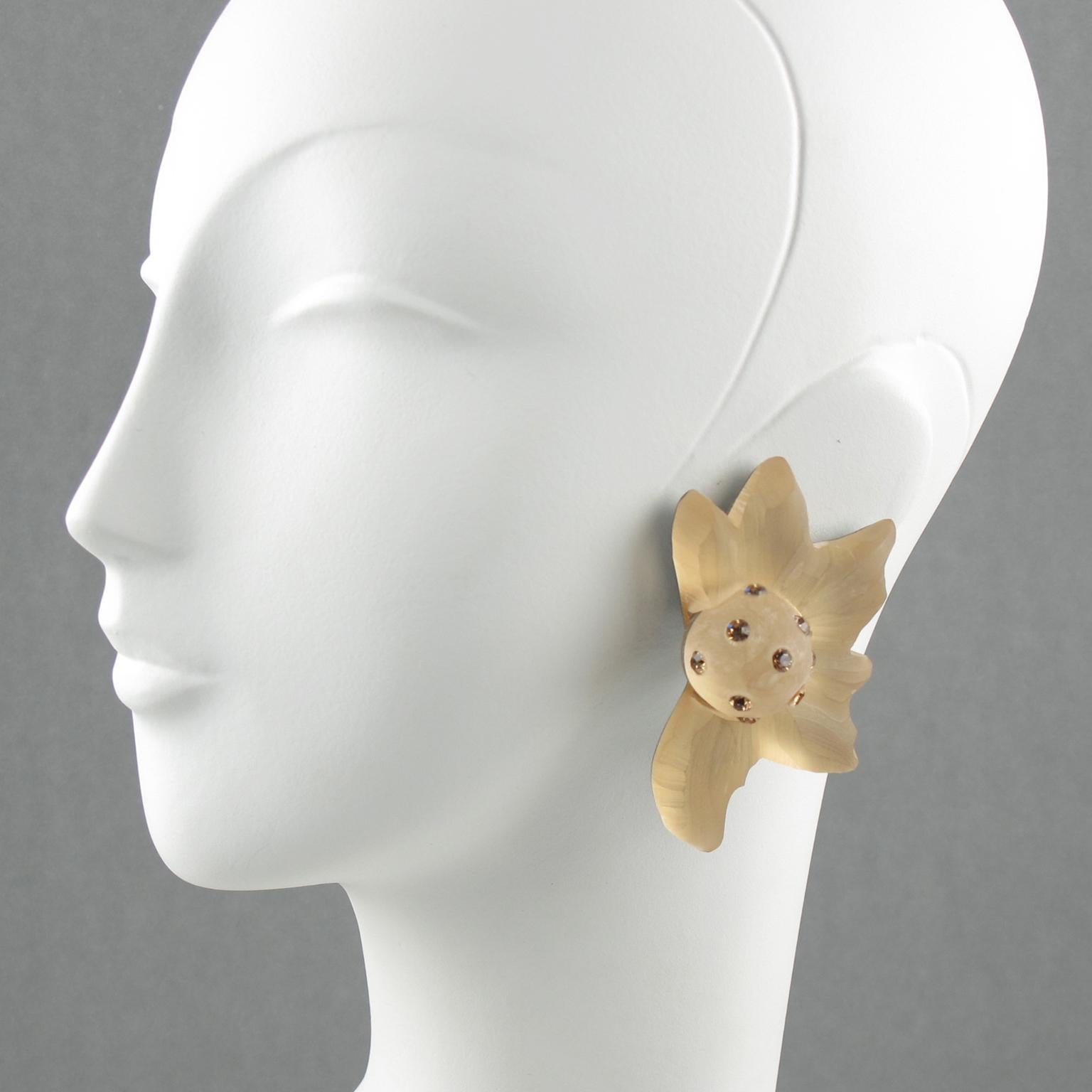 Harriet Bauknight for Kaso designed these stunning floral frosted Lucite clip-on earrings in the 1980s. They feature an oversized dimensional shape, all carved and textured in a beautiful flower in frosted champagne color ornate with light Colorado