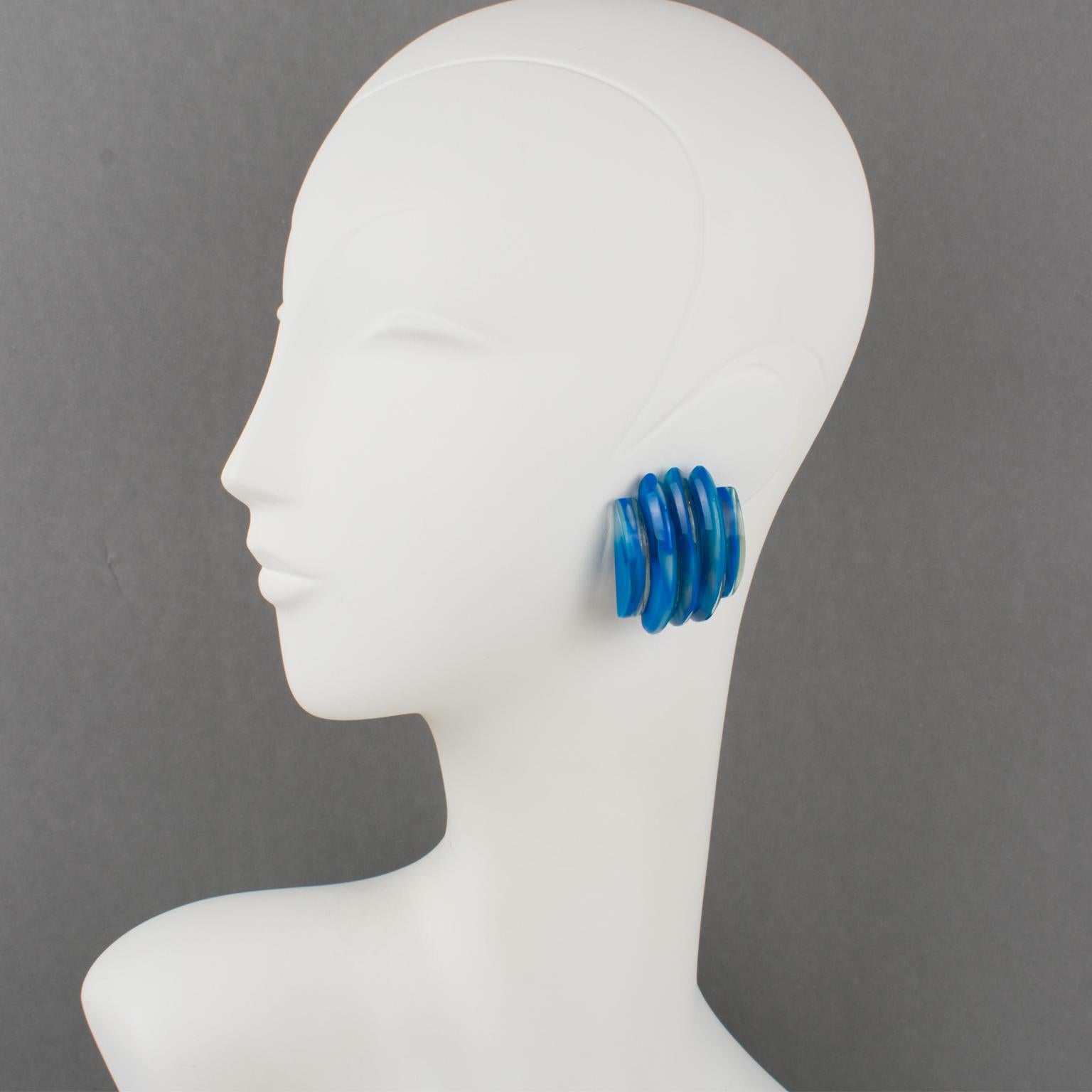 Gorgeous Lucite clip-on earrings designed by Harriet Bauknight for Kaso. Featuring a large dimensional domed shape with a carved striped pattern in cobalt blue swirling color. 
Kaso paper sticker missing but the specific rotating clip back is an