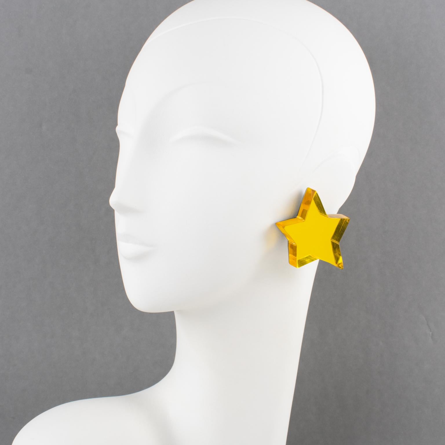 Harriet Bauknight for Kaso designed those stunning oversized Lucite clip-on earrings in the 1980s. The star shape features a dimensional layer with a bright yellow mirror texture pattern. The intense color is achieved with a multilayer lamination