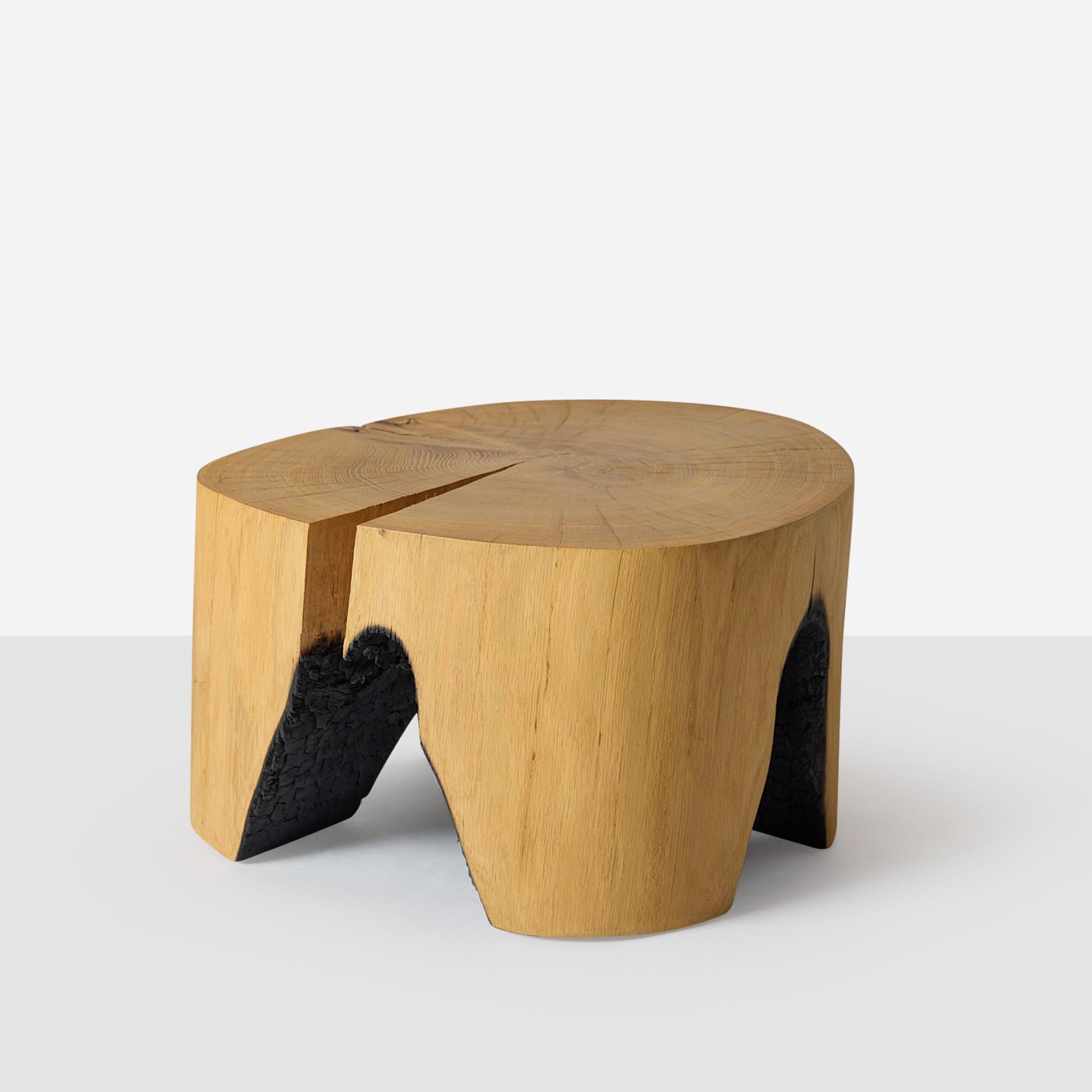 A stool formed by the hollowing out of oak tree trunks using fire. The oak comes from naturally fallen trees and all are made by the German artist Kaspar Hamacher. Can be used as a coffee table/side table. 