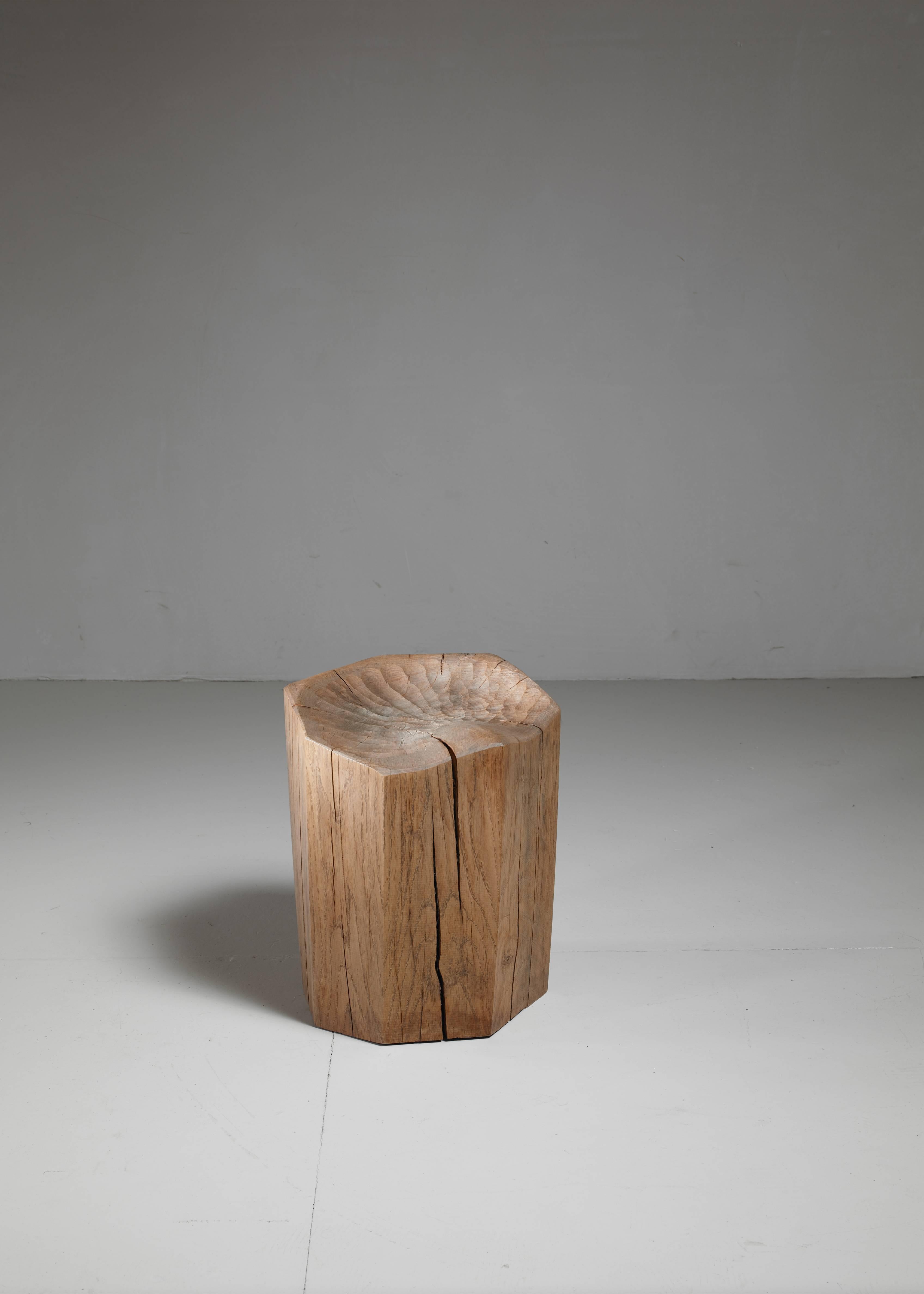 A beautifully carved oak 'der Sitz' stool by Kaspar Hamacher. The piece is made of a solid piece of oak, from a naturally fallen tree and has a beautiful mild patina. 

Hamacher (1981), son of a forester, uses nature as the main inspiration for