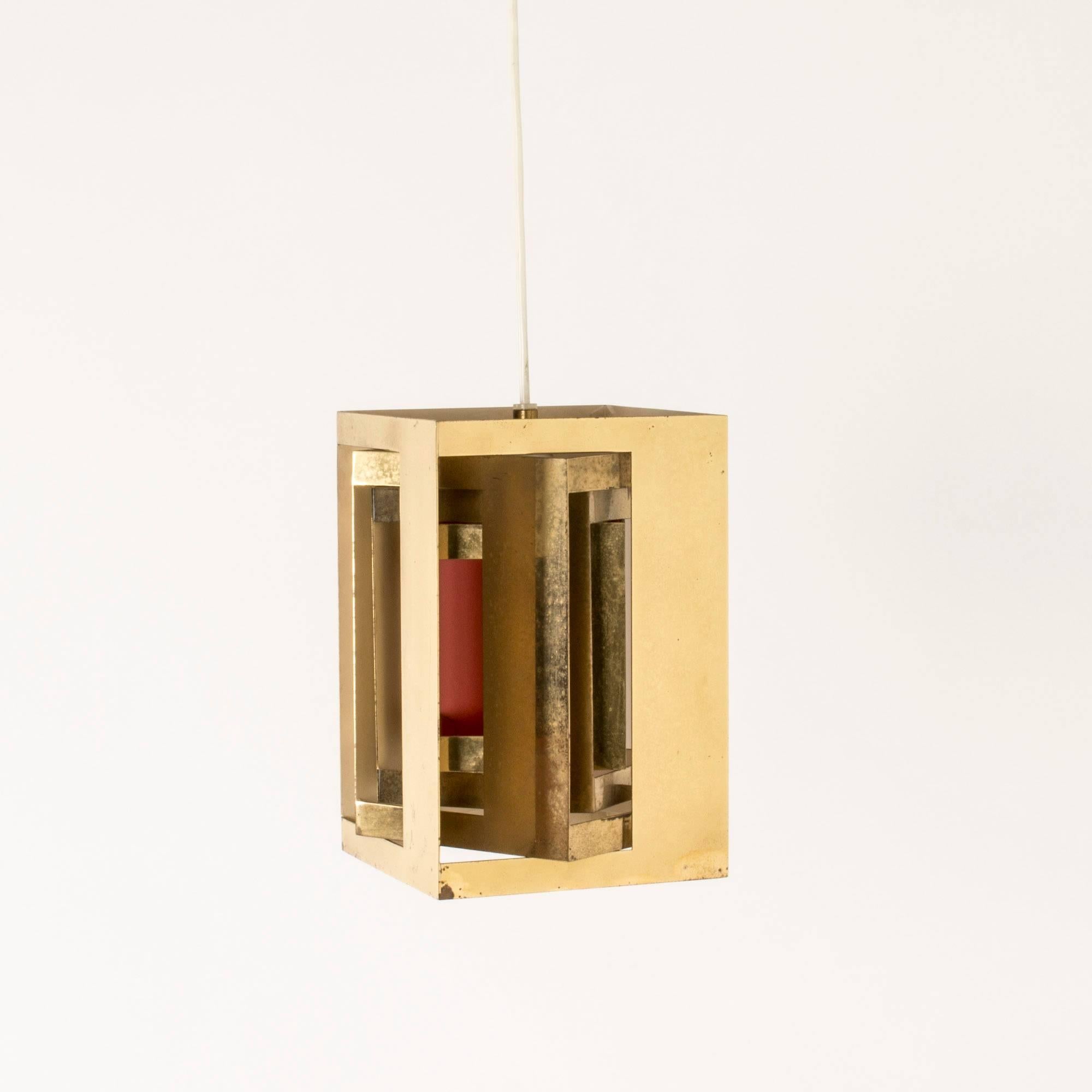 “Kassablanka” pendant lamp by Simon Henningsen, made from brass with some sides lacquered orange inside. Ingenious design that lets the light out beautifully.