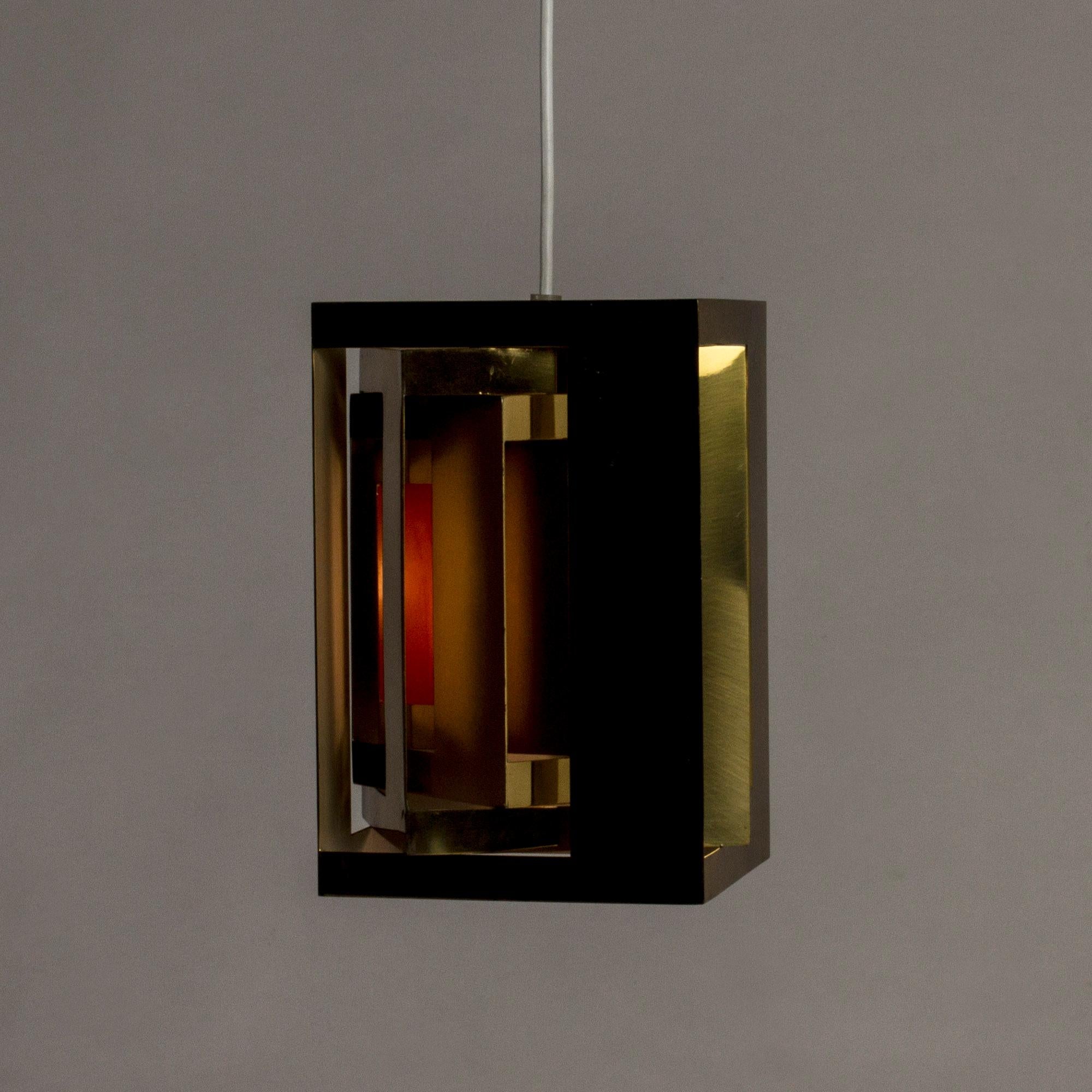 “Kassablanka” pendant lamp by Simon Henningsen, made from brass with some sides lacquered orange inside. Ingenious design that lets the light out beautifully.