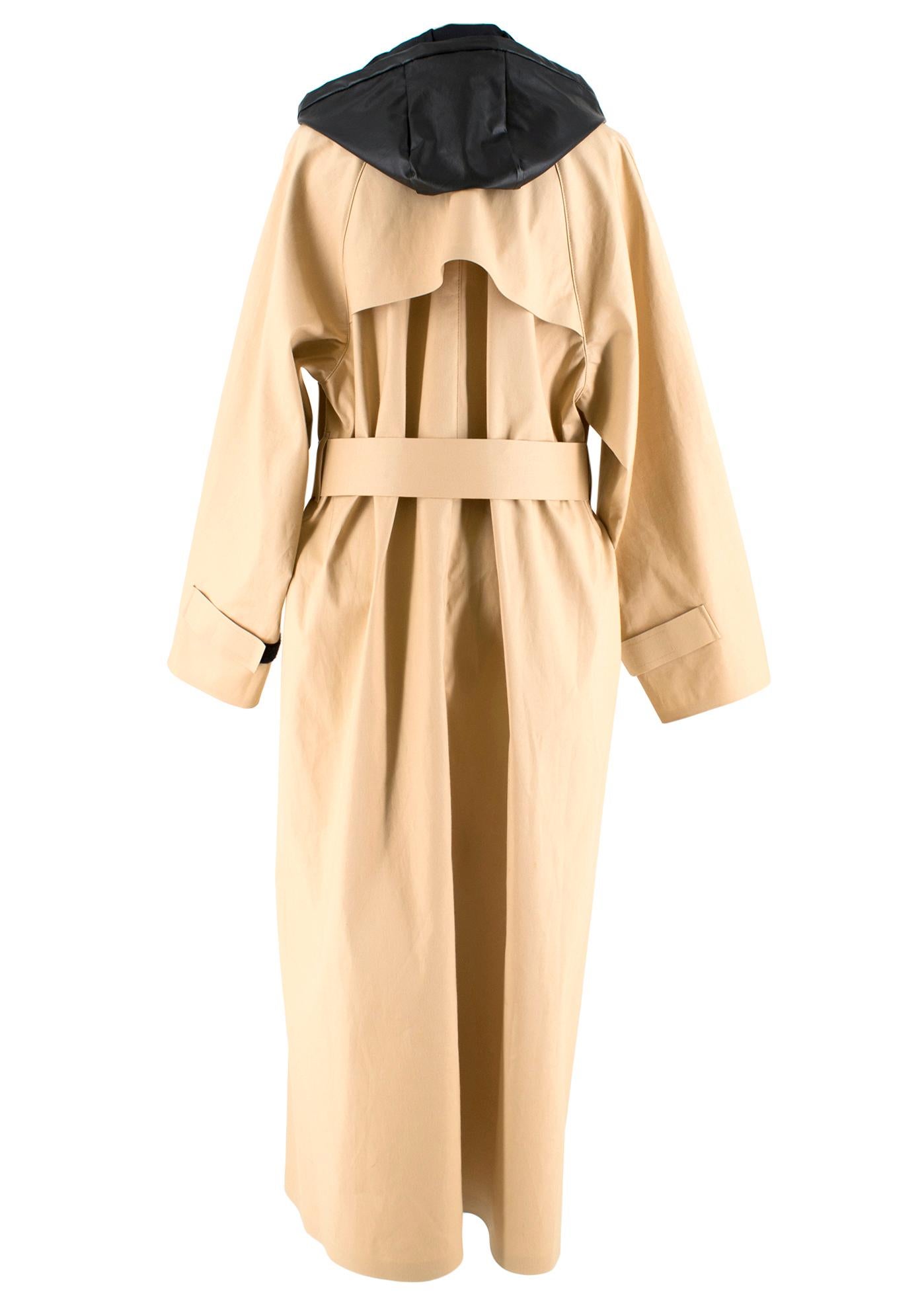 KASSL Editions woven trench coat (S)

Details:
Detachable hood
Contrasting panel at hood
Elasticated trim at hood
Long sleeves
Hook-and-loop straps at cuffs
Two flap pockets at front
Belt loops
Self-tie belt at waist
Contrast buttons
Overlay panel