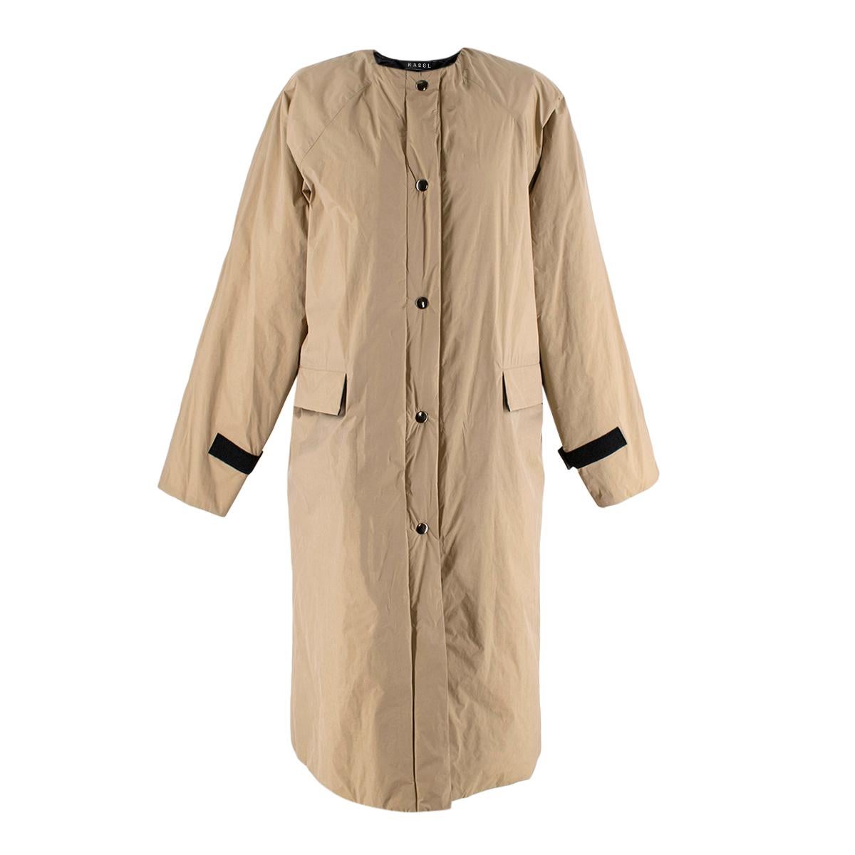 KASSL Editions Nude Coated Taffeta Padded Coat

- Elevated, industrially inspired lightly padded collarless coat
- Light camel colour, reflecting tones of khaki, gold and brown
- Contrasting black interior, zip, front poppers and velcro cuff