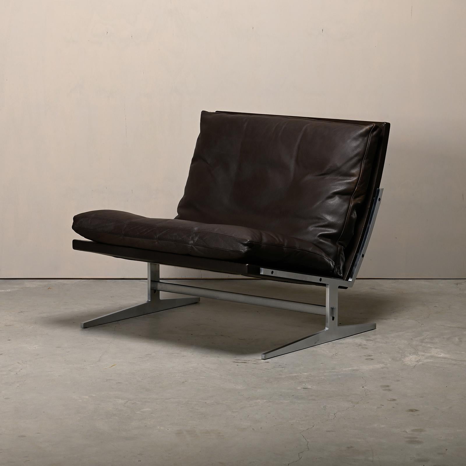 Beautiful lounge chair designed by Jørgen Kastholm & Preben Fabricius model Bo-561 and produced by Bo-Ex in Denmark. Polished stainless steel frame with seat and back panel upholstered in chocolate brown leather. The cushions are also upholstered in