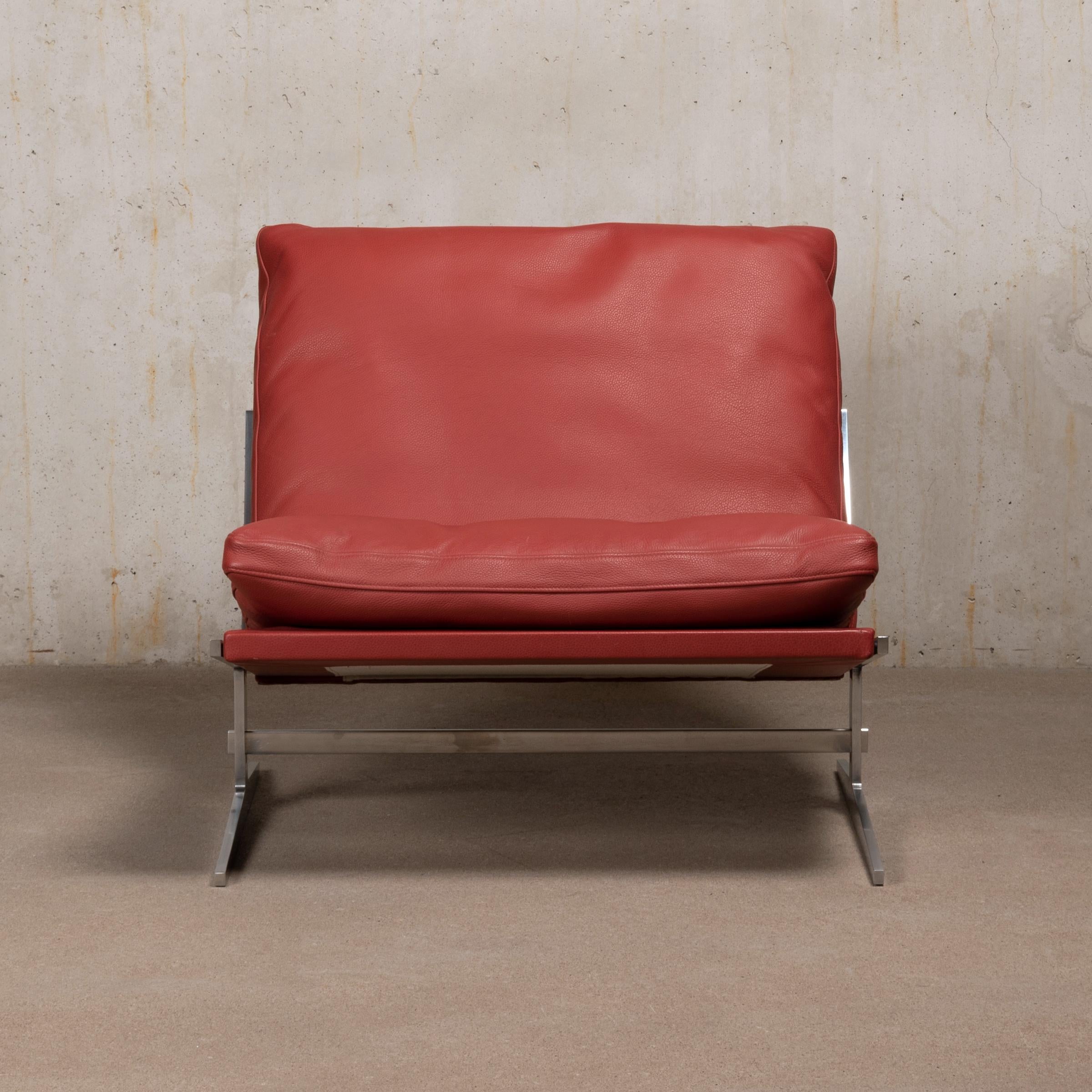 Beautiful slipper lounge chair by Jørgen Kastholm & Preben Fabricius model Bo-561 produced by Bo-Ex in Denmark. Polished steel frame and recent Ruby Red leather upholstery with down feathers filled cushions all in very good condition with only