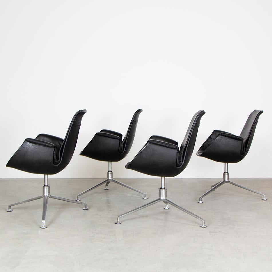 Bucket Tulip armchairs designed by Jørgen Kastholm & Preben Fabricius and produced by Walter Knoll, Germany. Aluminum polished swivel base with shell upholstered in black leather. All in original good condition with light traces of use.