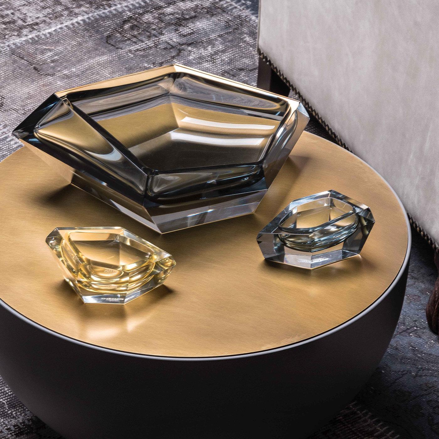 This elegant centerpiece is part of the Kastle collection designed by Karim Rashid in 2013. Distinctive for its multi-faceted, transparent surface that will reflect the surrounding light becoming a luminous object of functional decor, this tray can