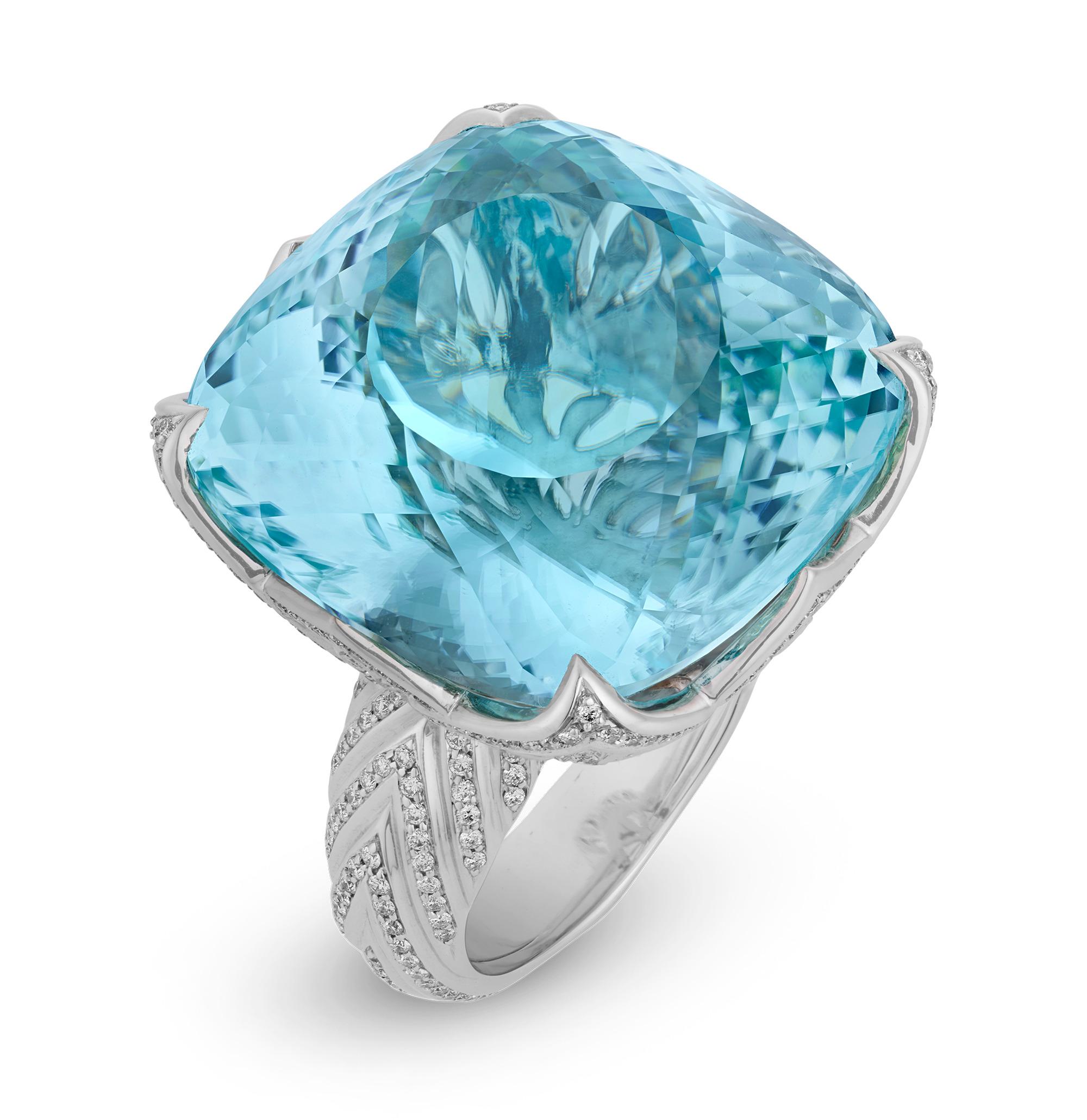 This extraordinary ring by Kat Florence showcases one of the most coveted gemstones in the world—a monumental 57.84-carat neon blue Paraiba tourmaline from Brazil. Its electrifying hue and expert faceting create an irresistible play of light. The