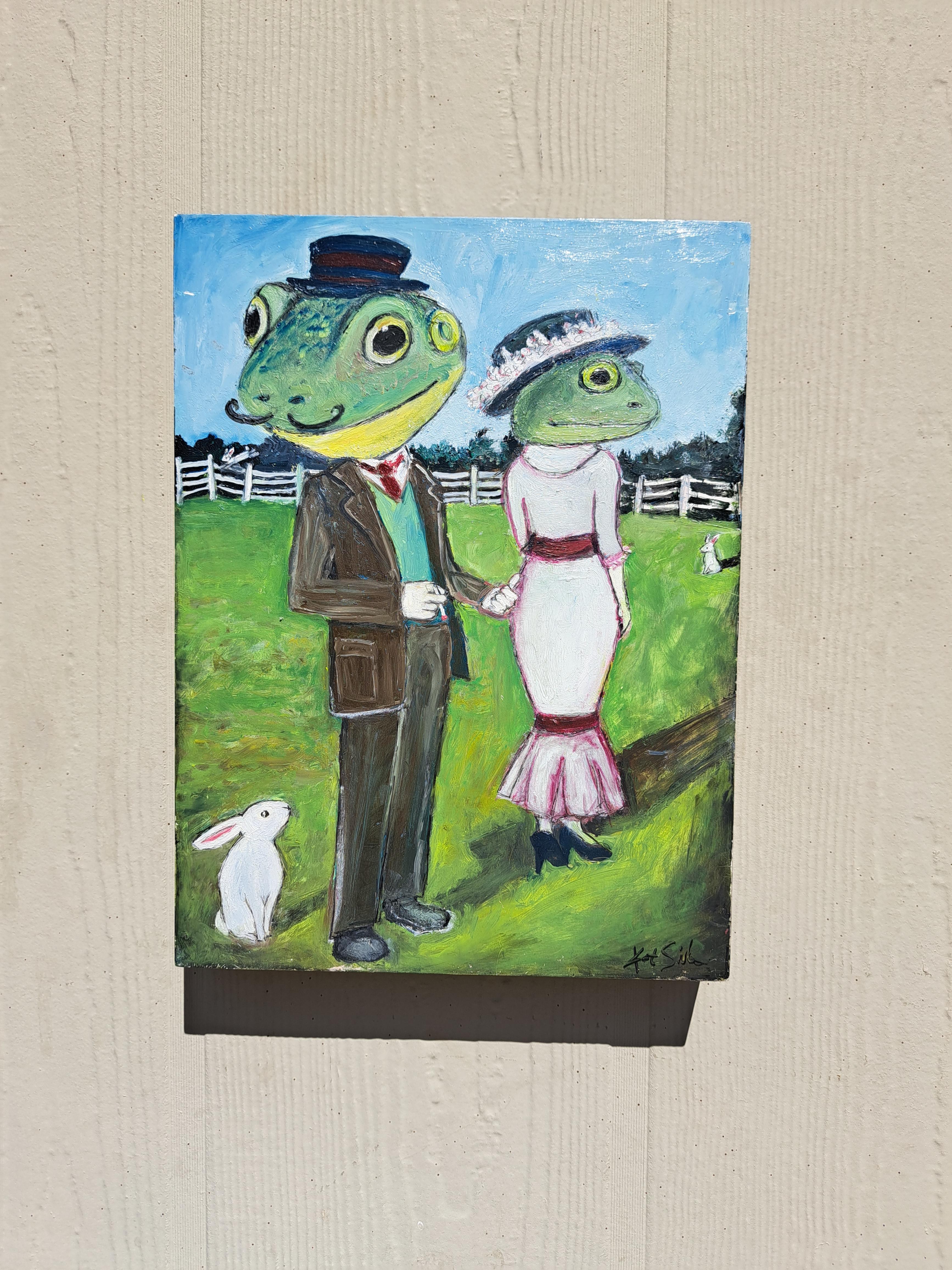 <p>Artist Comments<br>An old-timey frog couple stands together, but they seem to be miles apart. The artwork delves into the profound exploration of human connections, revealing how even within the closest bonds, individuals can wear masks and