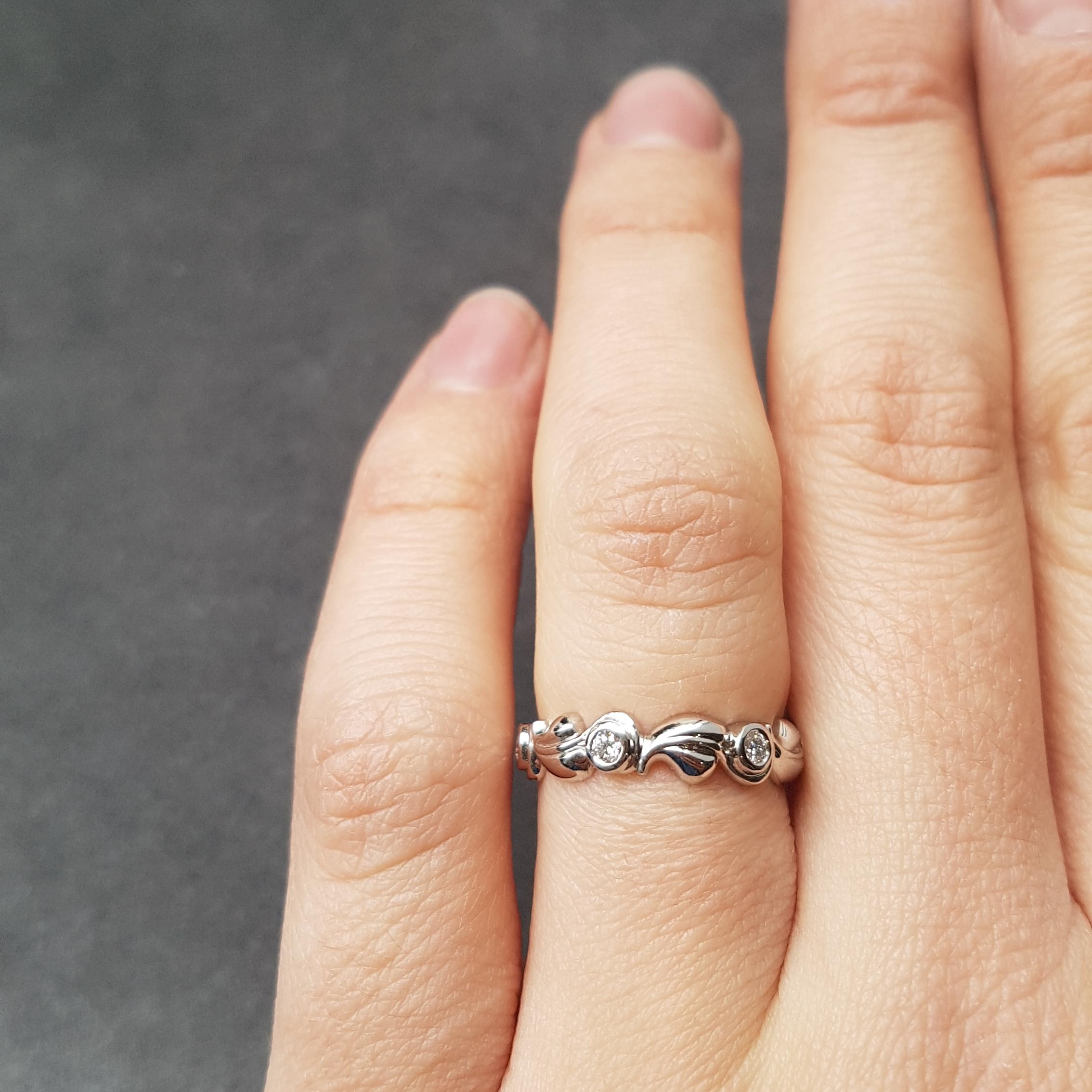 This delicate and sweet eternity ring is made in platinum. The leaf details are interspersed with six white diamonds.

Timeless natural beauty, the Grace band is a charming eternity ring when worn solo, but can be a more creative statement when