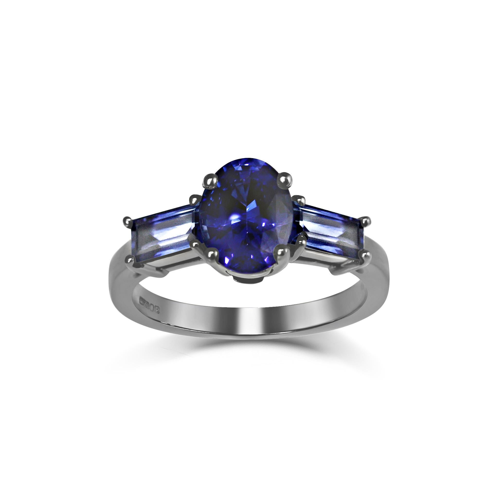 Beautiful clear blue midnight pools reflecting the light of the Moon, bound in shadow and mystery.
The enigmatic Luna ring, a ring as unique as she is.	

KATA Jewellery's Unique Oval & Baguette Sapphire Three Stone Trilogy Ring with Black Rhodium is