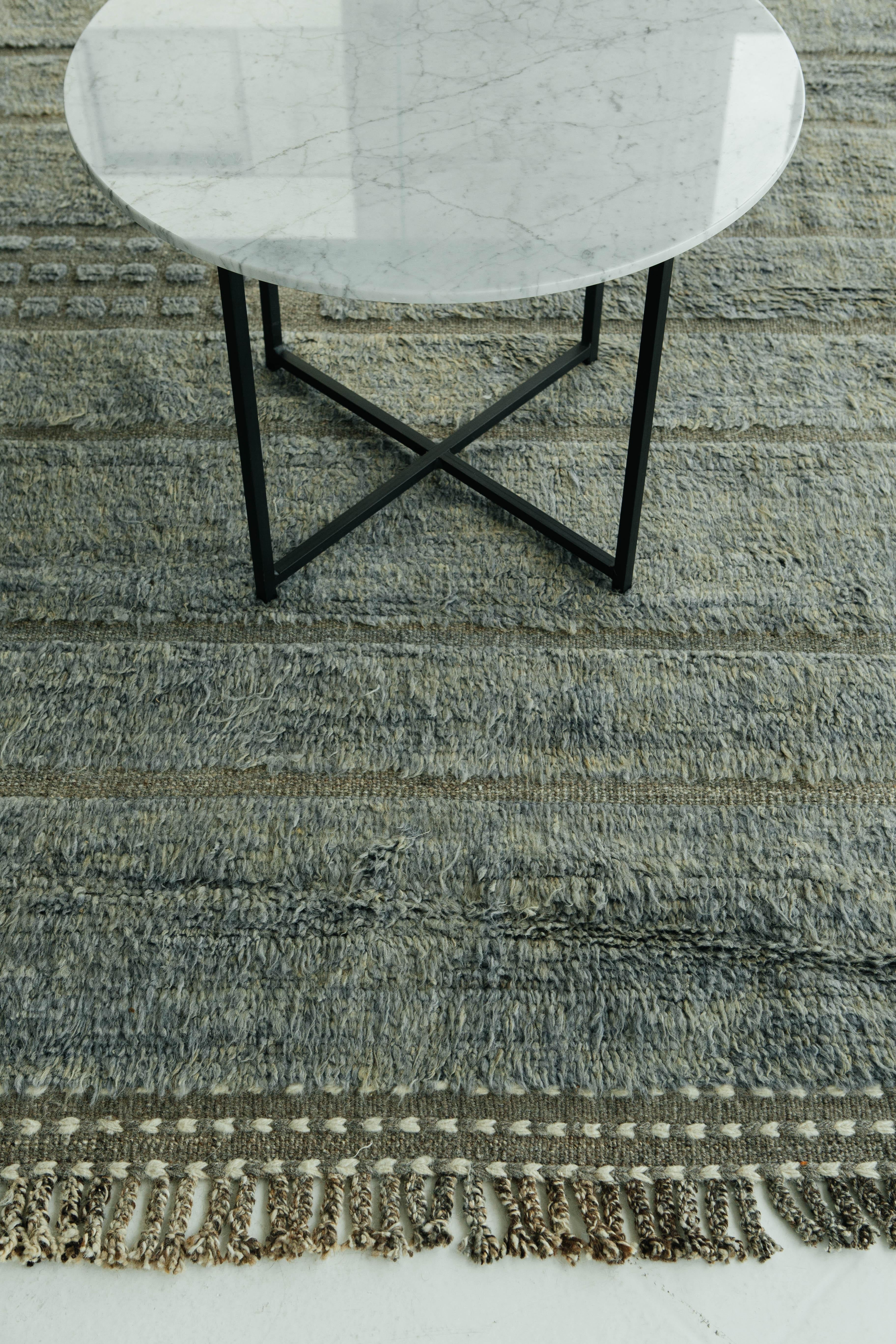 Katabatic is handwoven of a blended blue and green shag on a natural olive green flat-weave with embossed detailing. Designed in Los Angeles with immense detail, Katabatic is meant to be lived on and can withstand high amounts of foot
