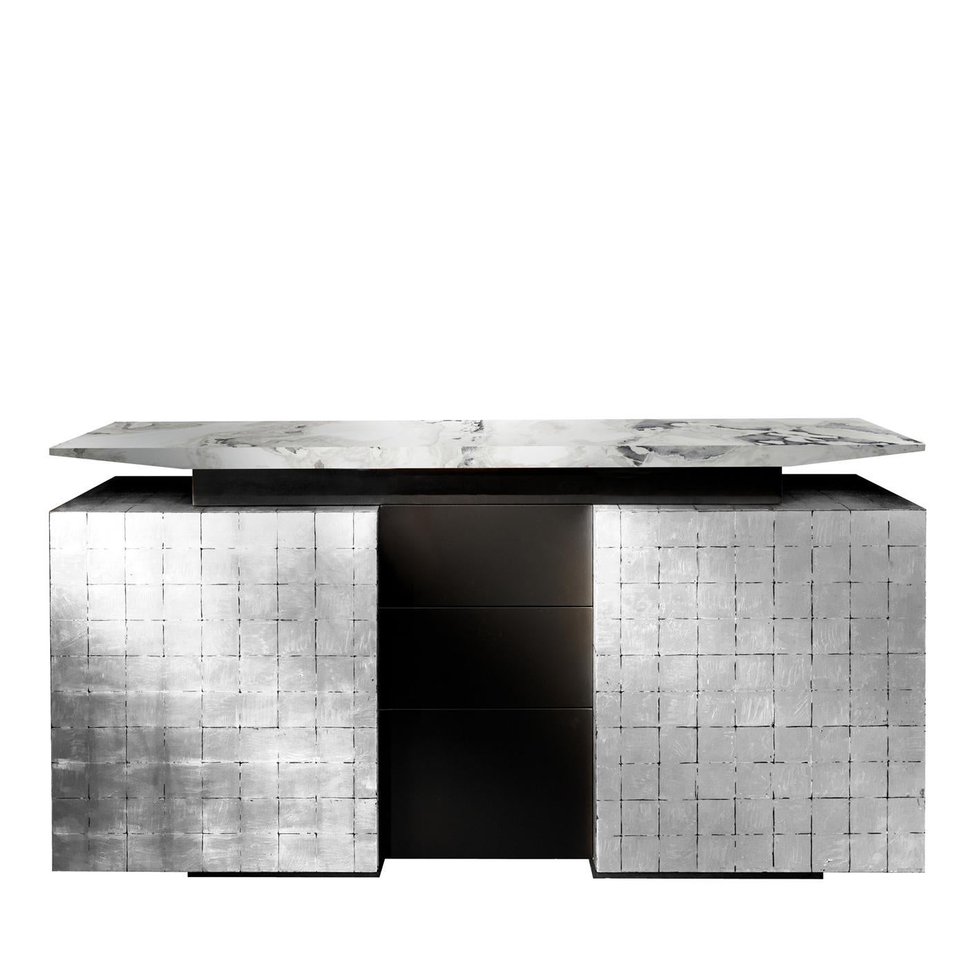 This magnificent sideboard is composed of two silver-finished doors with inner shelves, three middle drawers finished with a matte black polyurethane lacquer, and a splendid top fashioned of Dover white marble. A combination of refined materials,