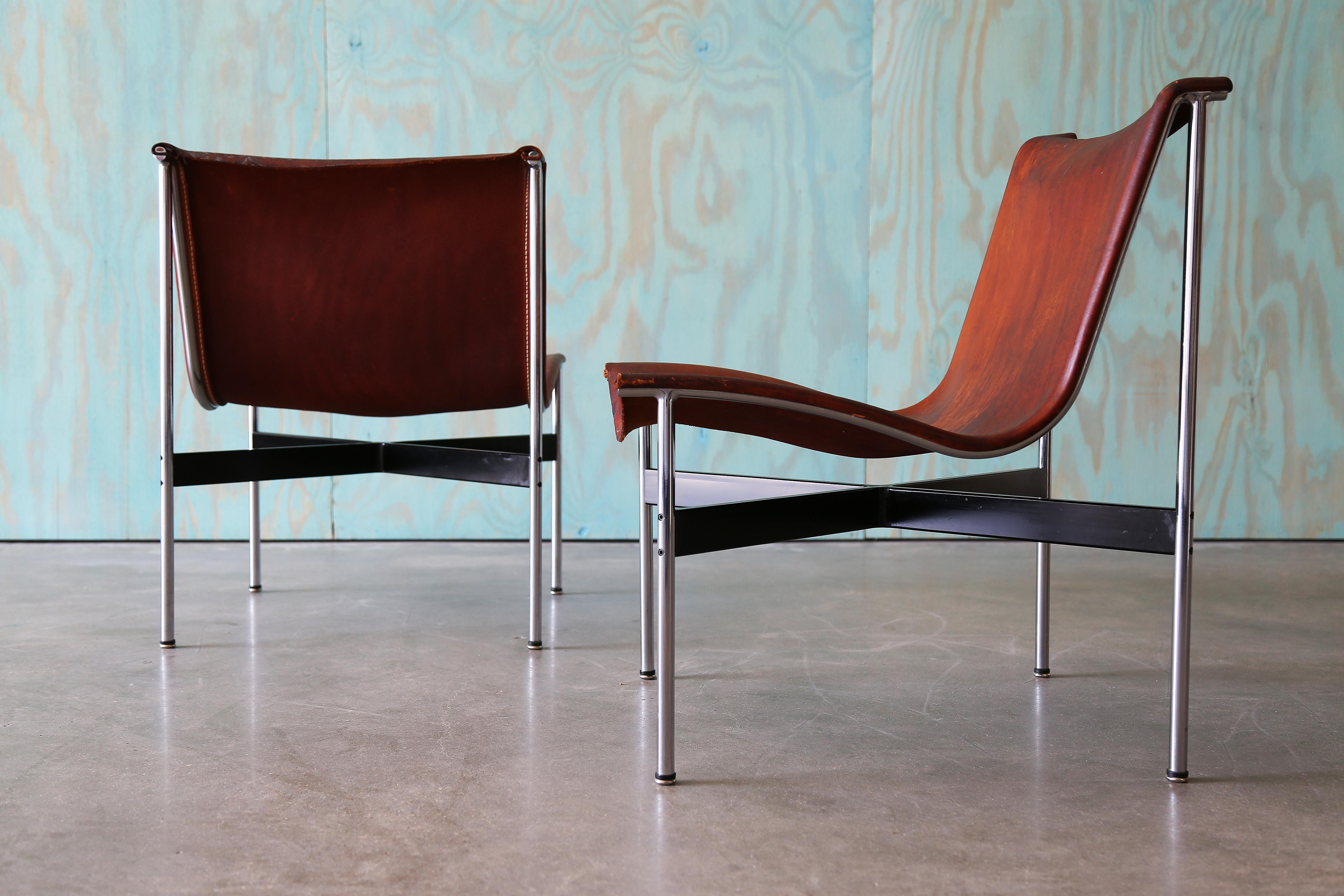 Pair of iconic New York lounge chairs by William Katavolos, Ross Littell, and Douglas Kelley for Laverne Originals, circa 1953. Featuring original leather slings with age-appropriate wear—darkened areas, minor stains, and crazing. Tear in leather on