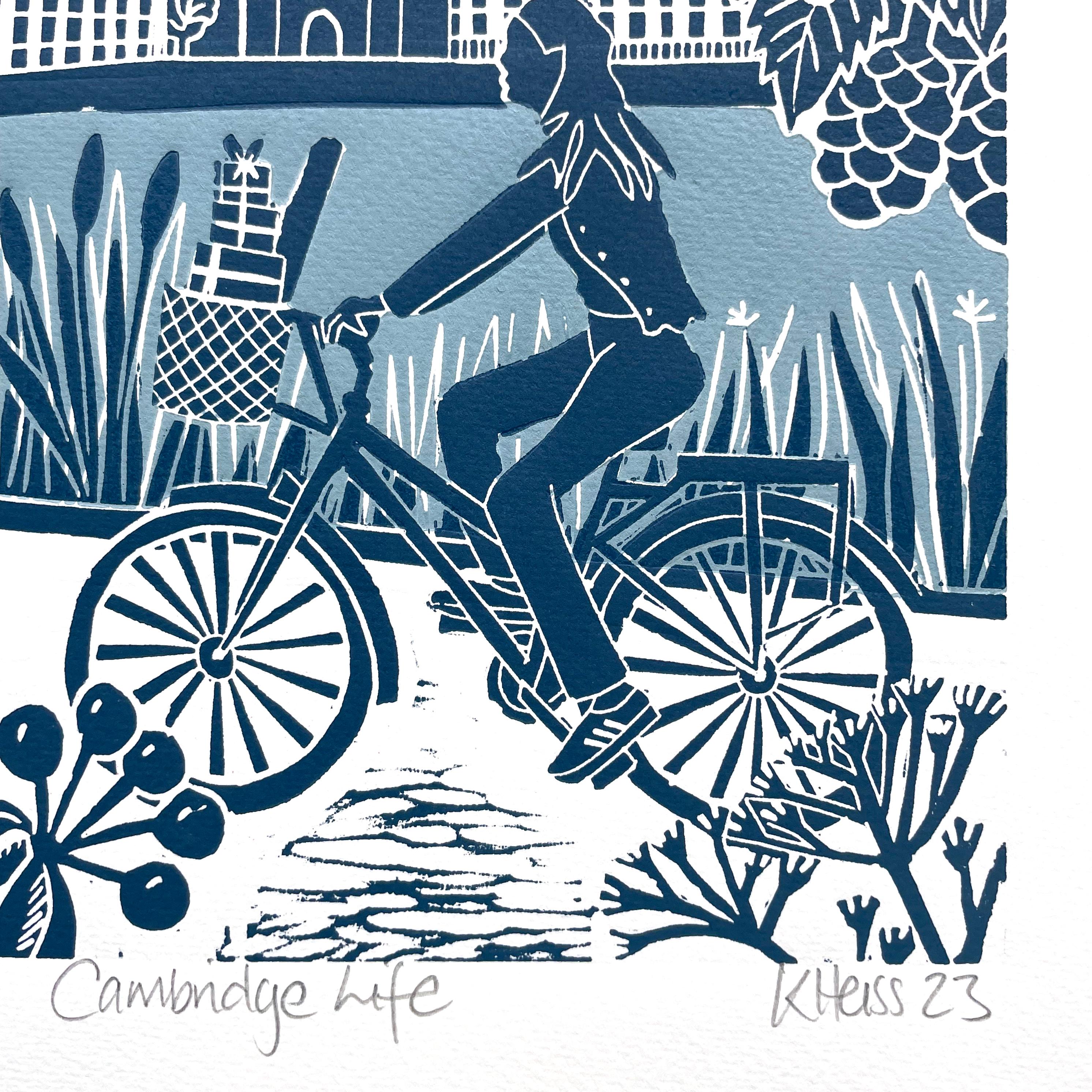 This is a handmade Linocut relief print of a cyclist riding along the Backs of Cambridge with Kings College Chapel in the distance and a robin in the foreground. It is a limited edition linocut printed with duck egg blue, Prussian blue and scarlet