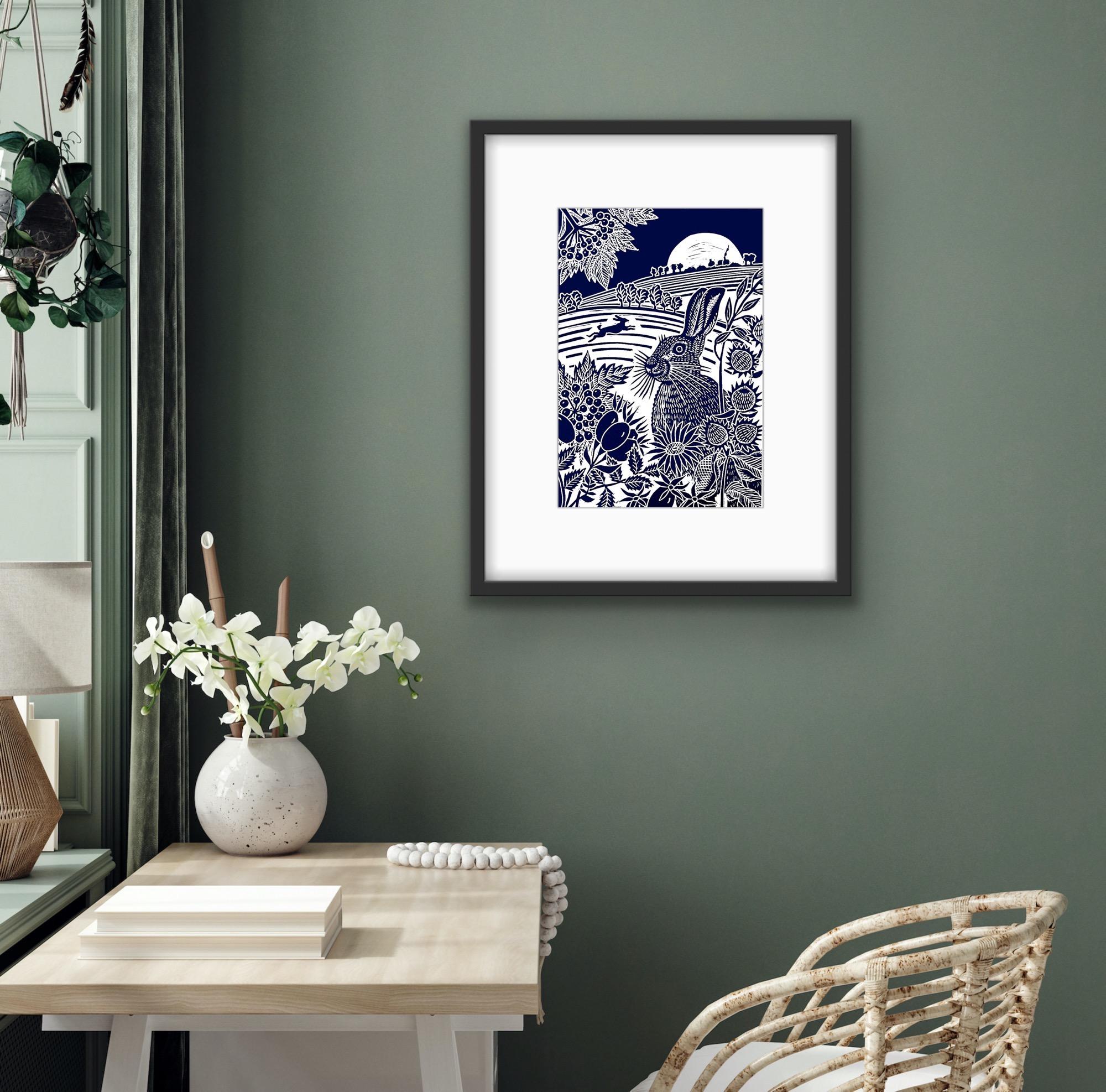 Harvest Moon Hares is a limited edition linocut print depicting a pair of Hares out on the fields under a harvest moon. Wild berries and rose hips are silhouetted in the foreground. Printed in Indigo blue
Kate Heiss is available with Wychwood Art