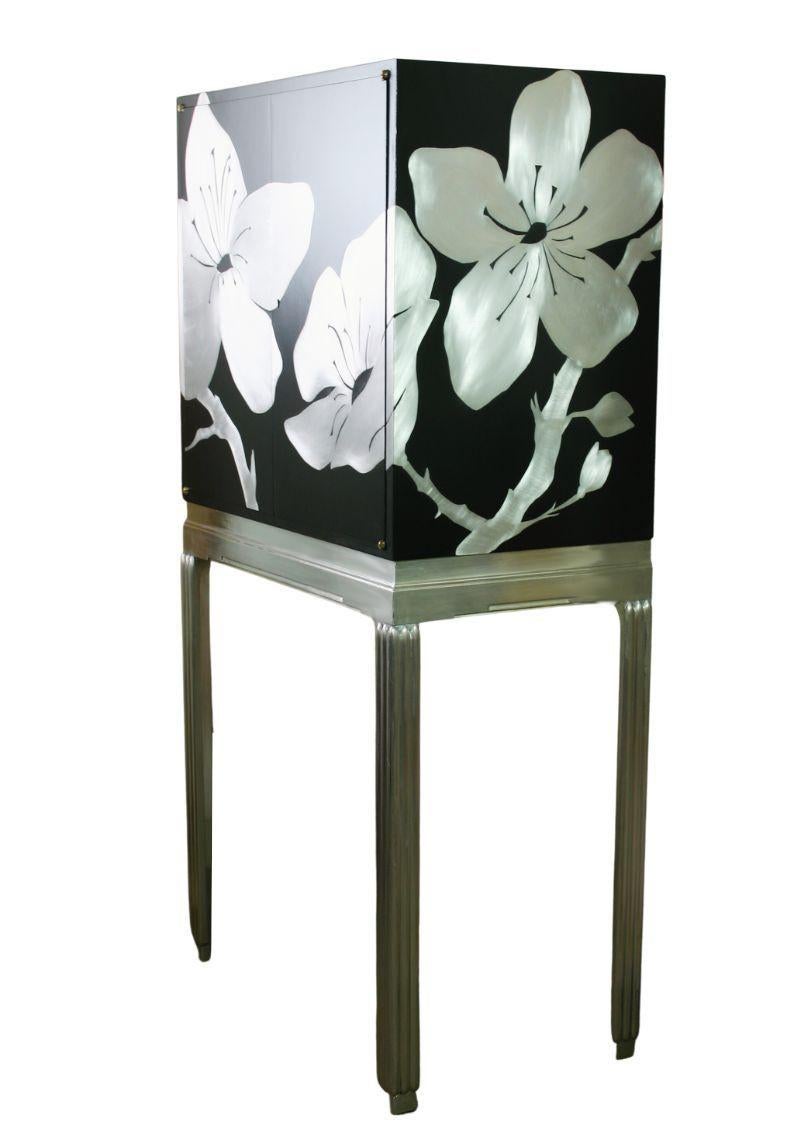 An Art Deco cocktail cabinet that has been reconditioned and reimagined by designer and maker Kate Noakes. Kate uses a unique process that she has developed of cutting her original designs in sheet metal that are applied onto existing furniture and
