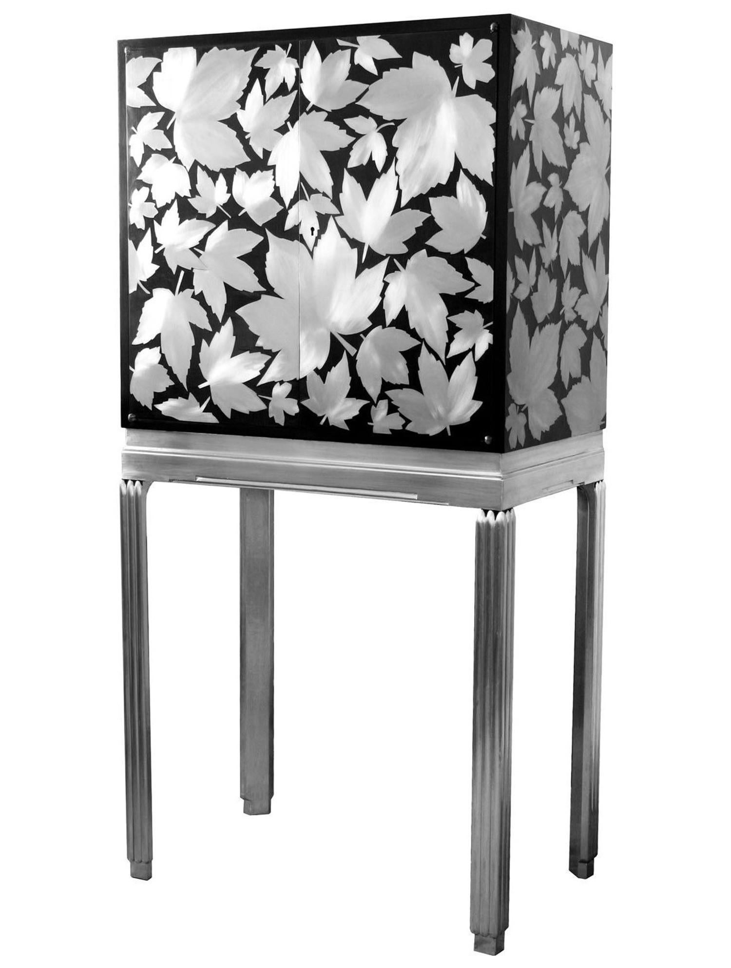 
 An Art Deco cocktail cabinet that has been reconditioned and reimagined by designer and maker Kate Noakes. Kate uses a unique process that she has developed of cutting her original designs in sheet metal that are applied onto existing furniture