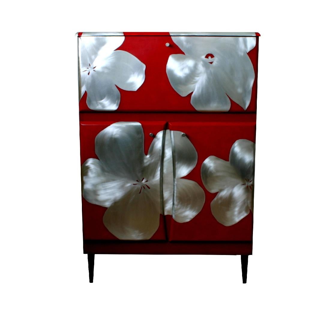 A mid century Cocktail cabinet with a cantilevered top that opens to reveal a mirrored interior. This has been reconditioned and reimagined by designer and maker Kate Noakes using a unique process that Kate has developed of cutting her original