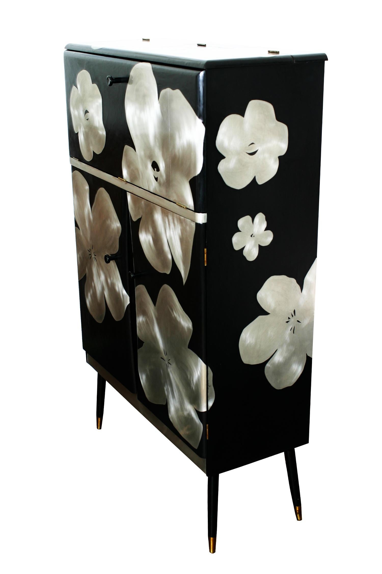 A mid century Cocktail cabinet with a cantilevered top that opens to reveal a mirrored interior. This has been reconditioned and reimagined by designer and maker Kate Noakes using a unique process that Kate has developed of cutting her original