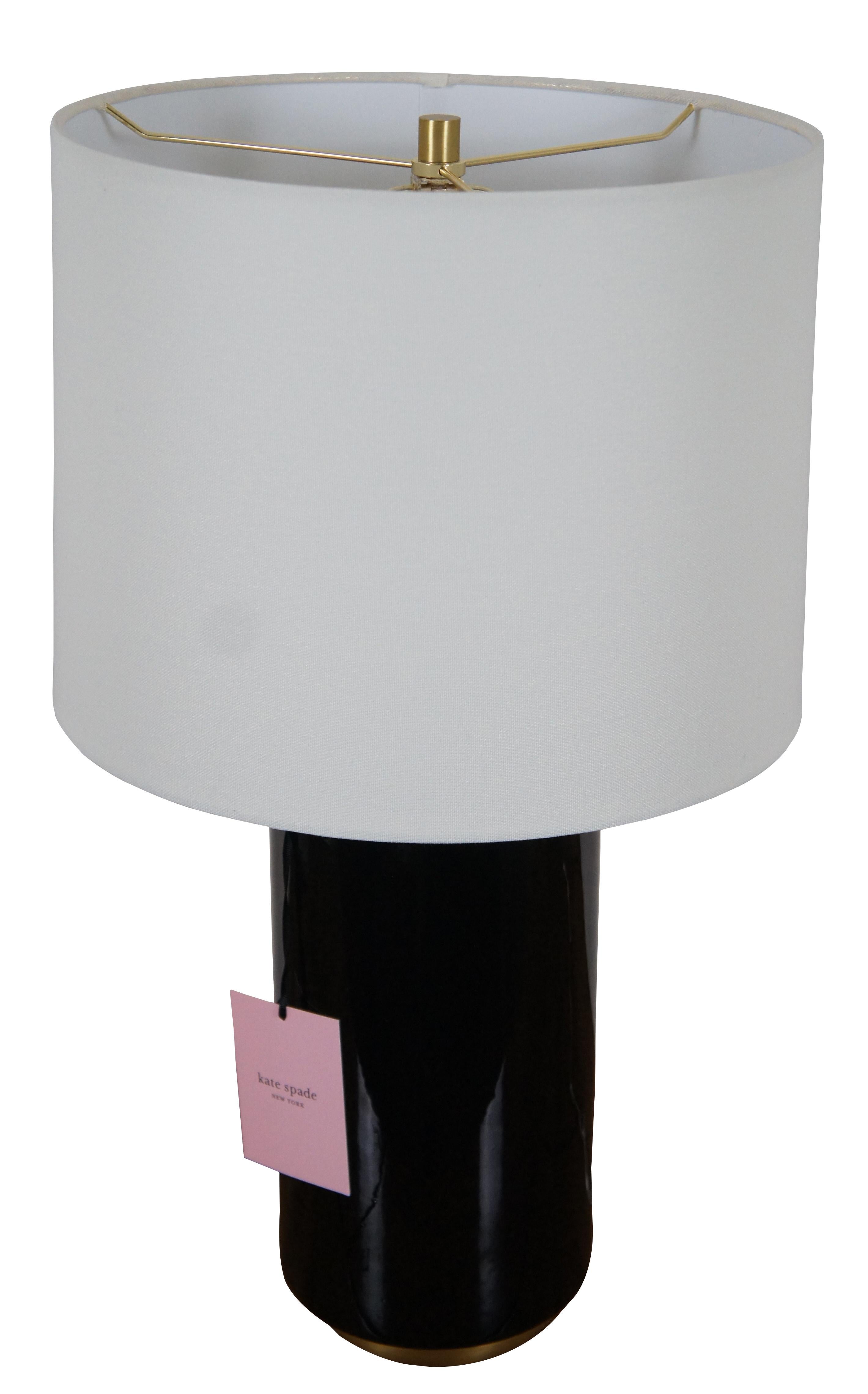 Kate Spade New York black porcelain cylindrical jar shaped table lamp with brushed brass base and top. Includes white shade.

Measures: 6.5” x 18” / shade - 14.5” x 10.75” / total height – 24.75” (diameter x height).