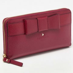 Kate Spade - Portefeuille zippé en cuir avec nœud en Bourgogne