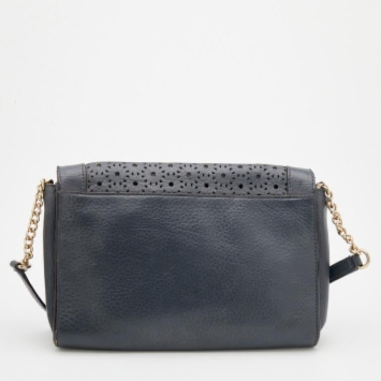 This shoulder bag from Kate Spade exudes the right amount of class and elegance. Crafted from dark-grey perforated leather, this bag is adorned with a shoulder strap and gold-toned hardware. It accommodates a fabric-lined interior. Make this bag