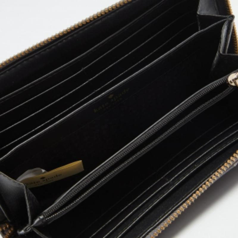 Made of quilted leather, this zip-around wallet from Kate Spade is a classy choice. It opens elegantly to a smooth interior with ample space for your cards. This grey wallet is complete with the logo on the front.