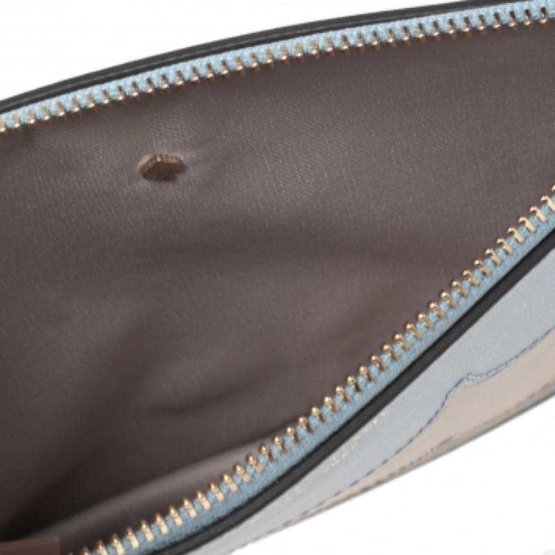 Add a hint of color to your style with this Intarsia wristlet from Kate Spade. It is made from multicolored leather and features gold-toned hardware and a fabric-lined interior.